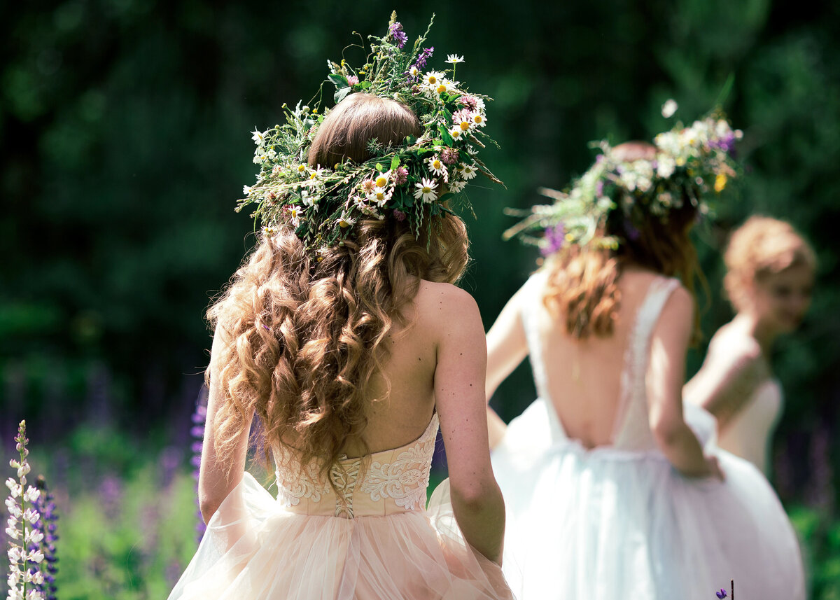 Boho bride and bridesmaids with floral crowns on a summers day.