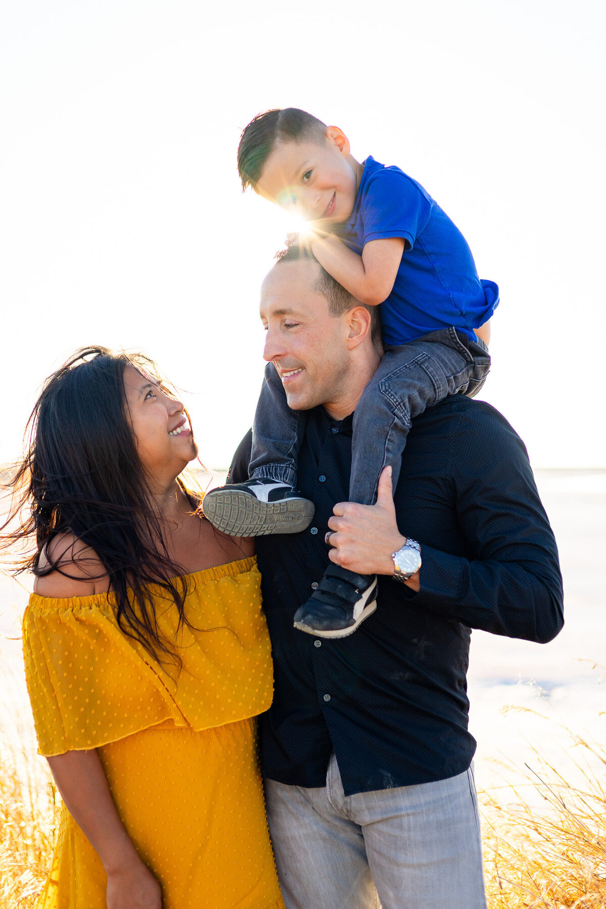 Playful moment with child on dad’s shoulders and mom smiling up – Bay Area Family Portfolio - Ellobelle Photography Family Photographer