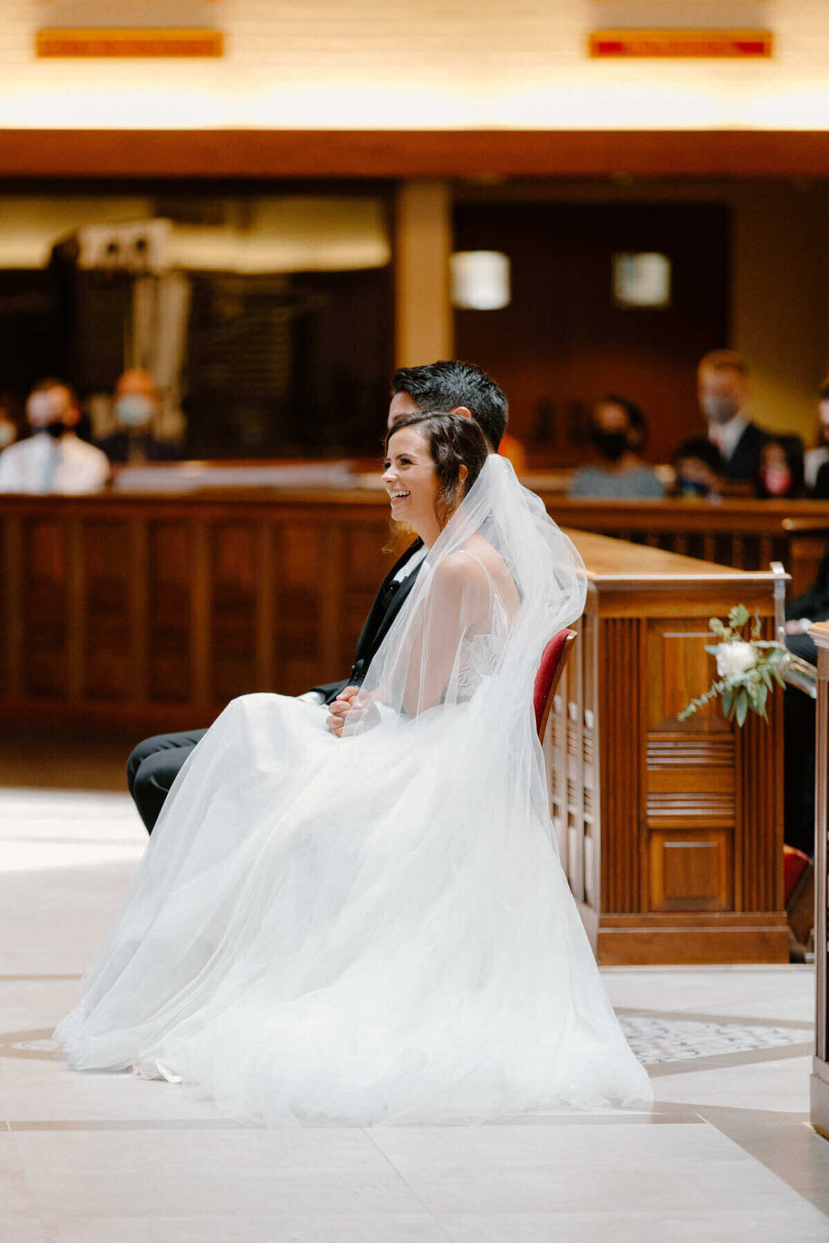 11-kara-loryn-photography-bride-and-groom-listen-to-wedding-mass