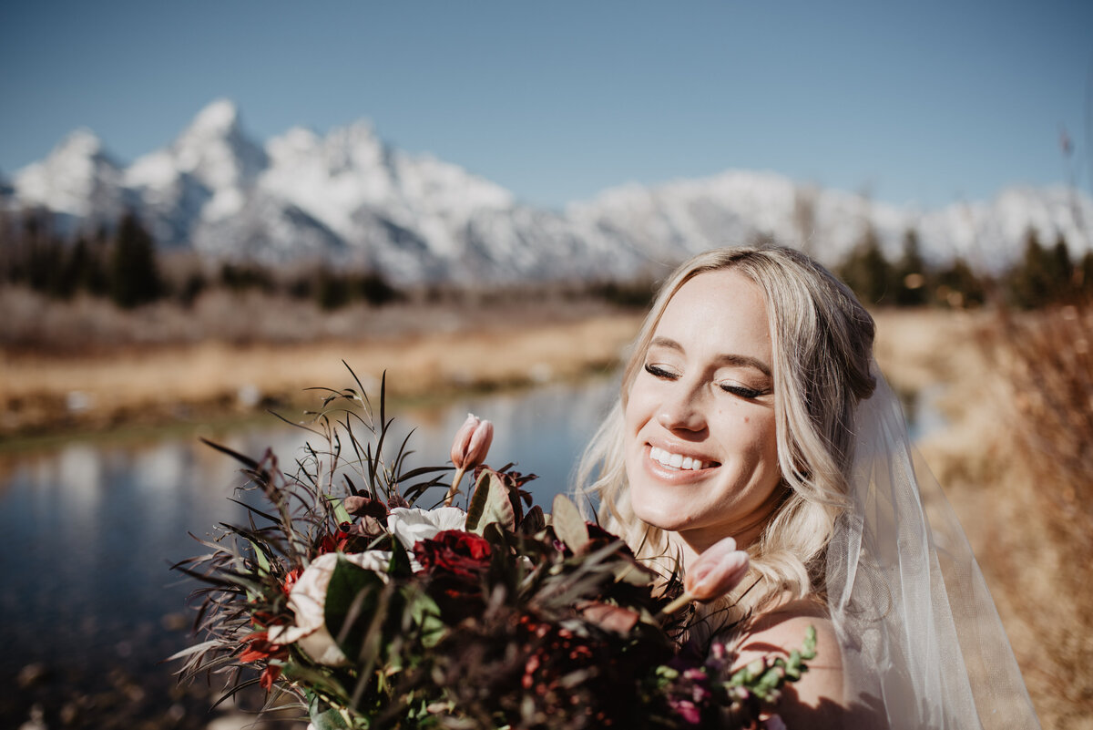 Jackson Hole Photographers capture bride smiling holding bouquet