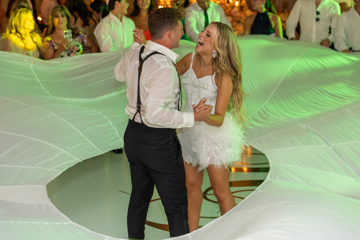 A bride and groom dancing inside of a circle