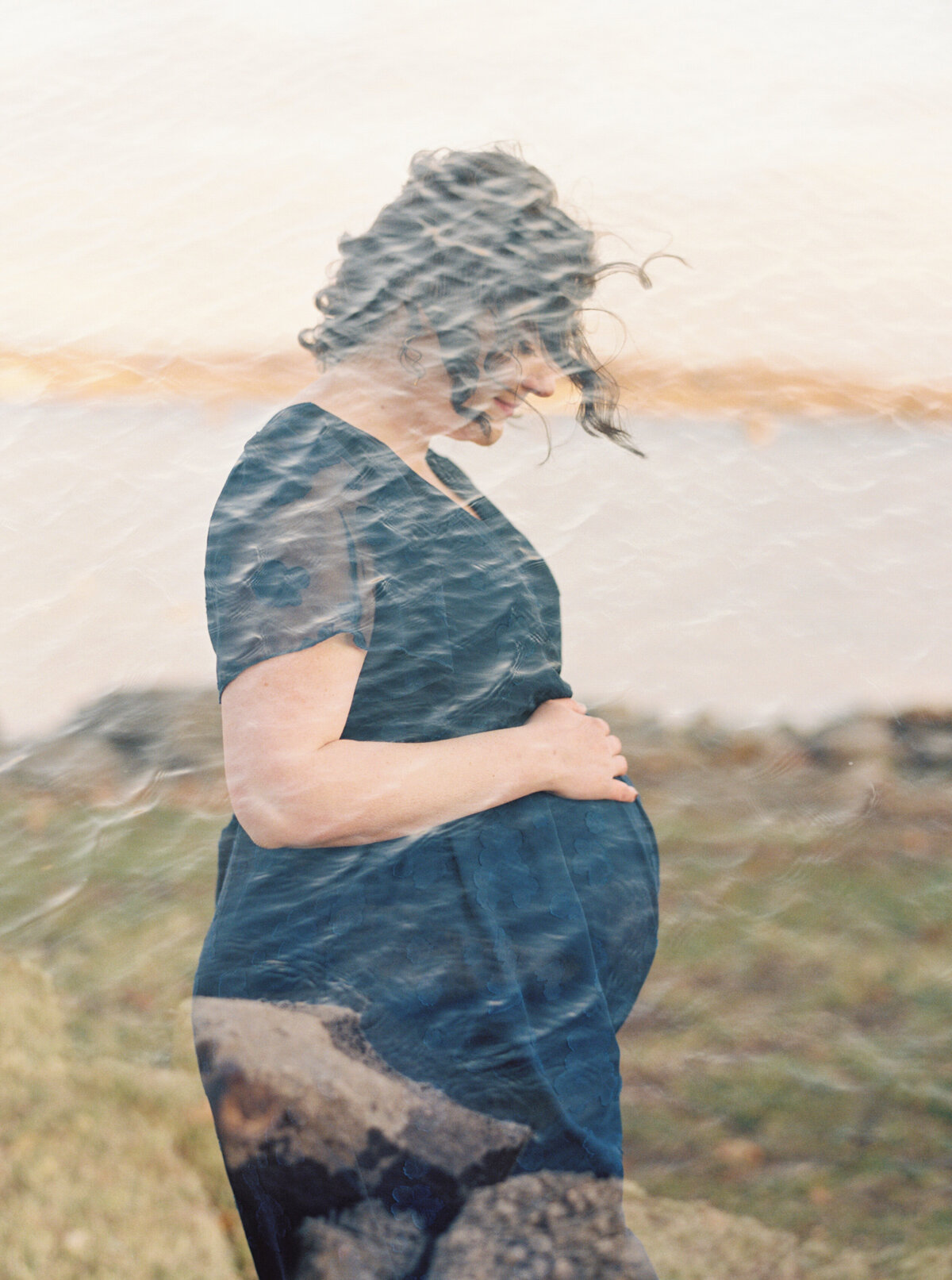 Double exposure of expectant mom over the water in Alexandria VA. Image by Raleigh maternity photographer A.J. Dunlap Photography.