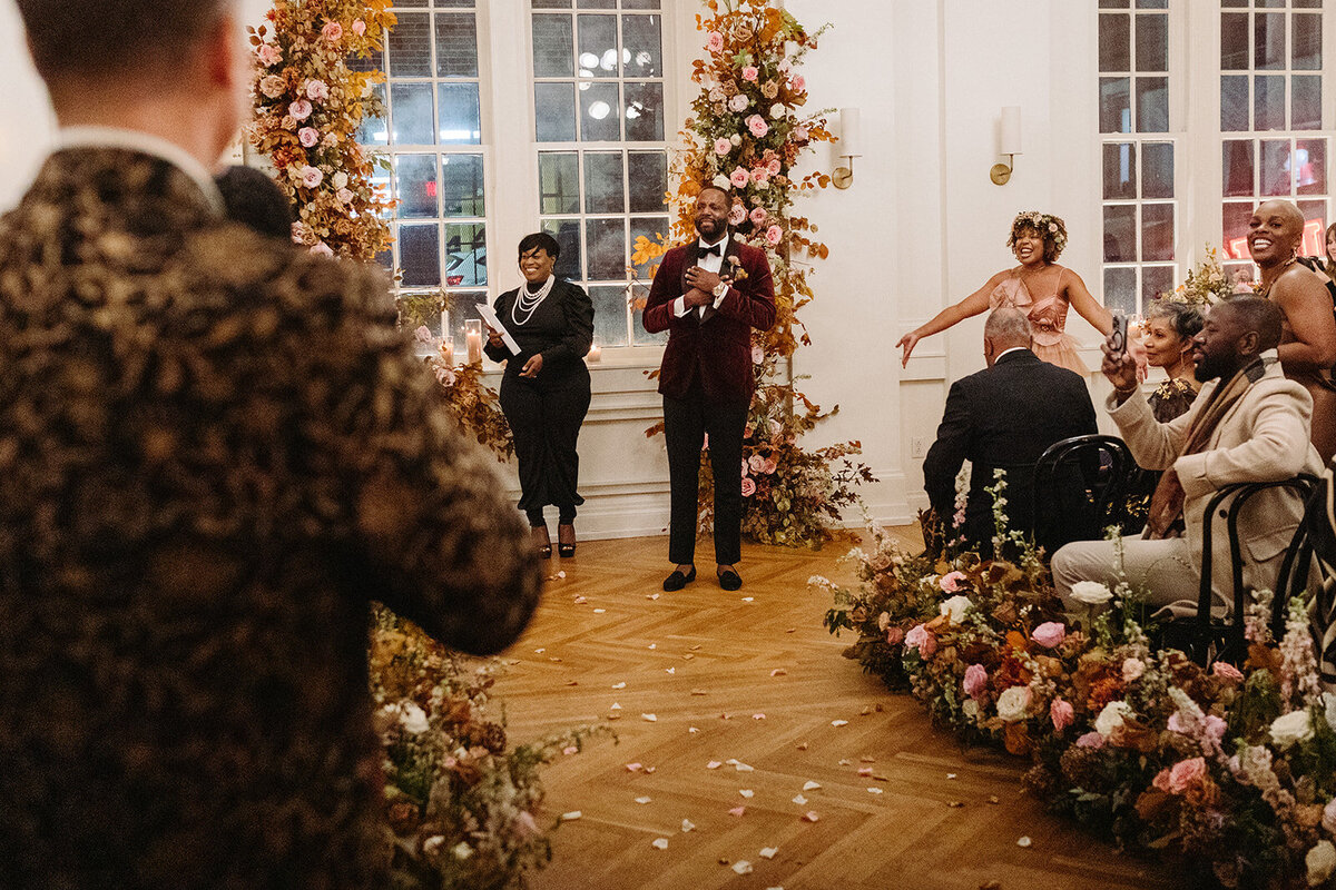 Lush aisle hedges line the entryway for this autumnal wedding with florals composed of roses, clematis, mums, delphinium, copper beech, and fall foliage creating hues of burgundy, dusty rose, copper, mauve, taupe, and lavender. Design by Rosemary and Finch in Nashville, TN.