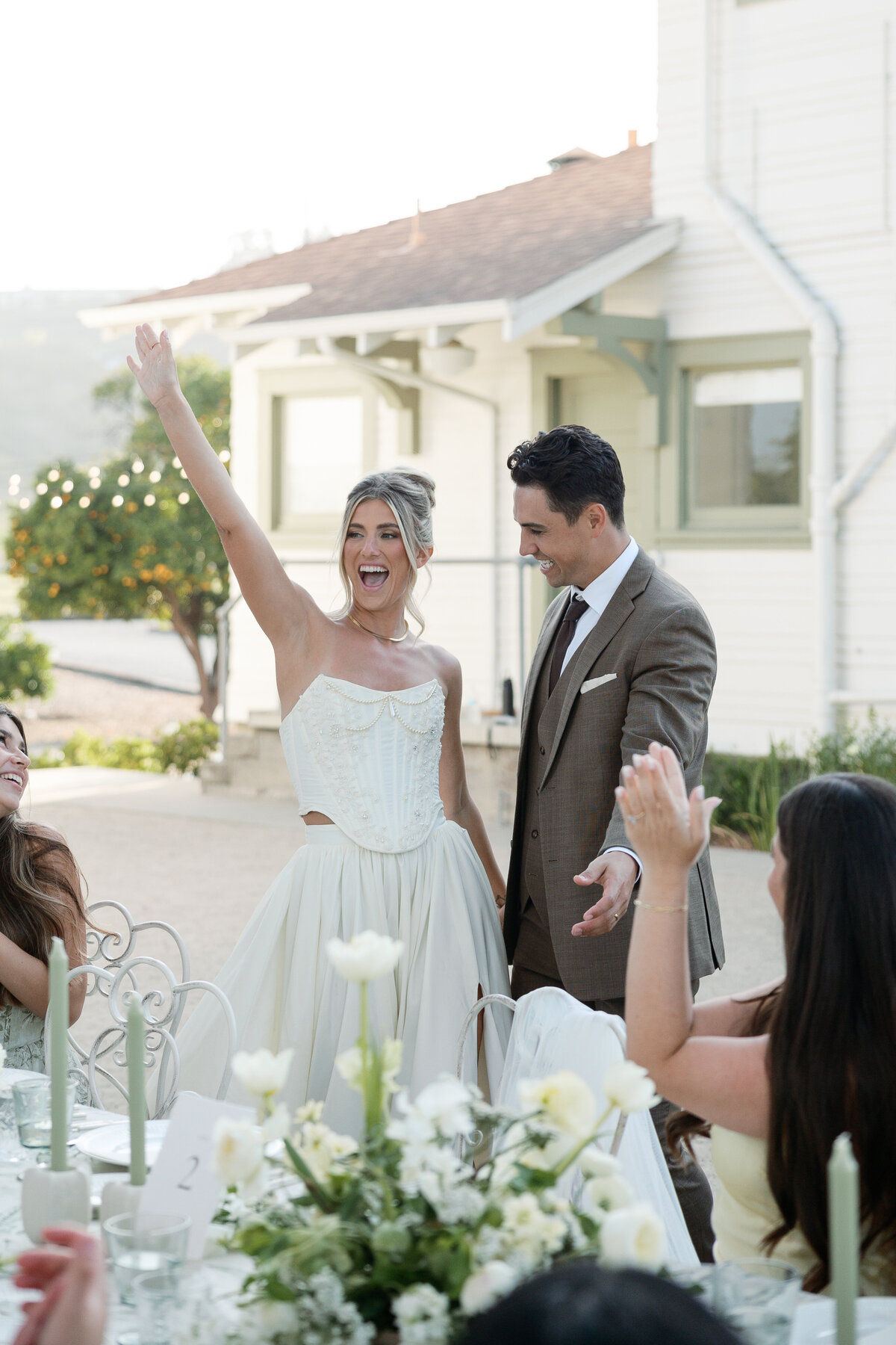 Bride and groom laughing during toasts, captured by a La Jolla wedding photographer.