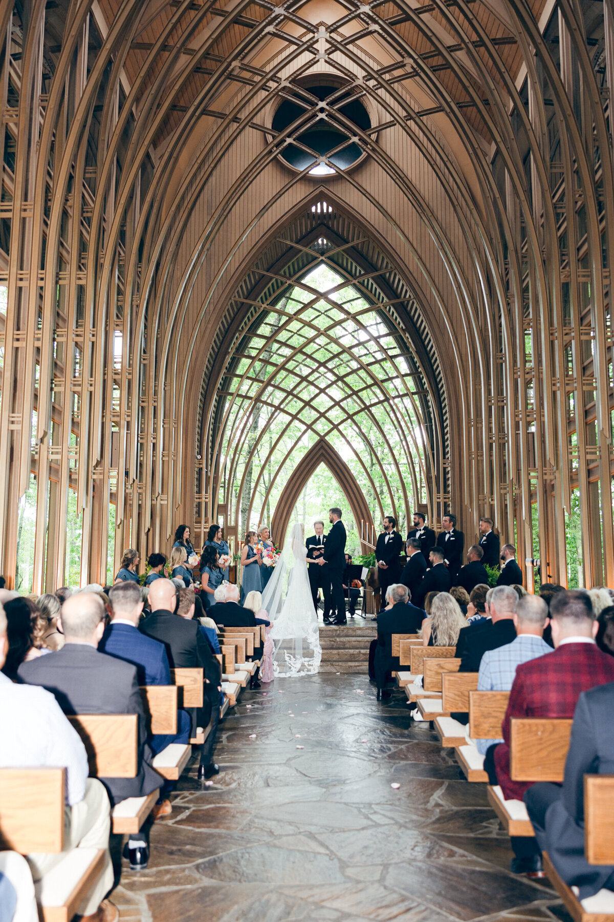 A wedding photo of the bride and groom on the alter at Anthony's Chapel in Hot Springs Arkansas