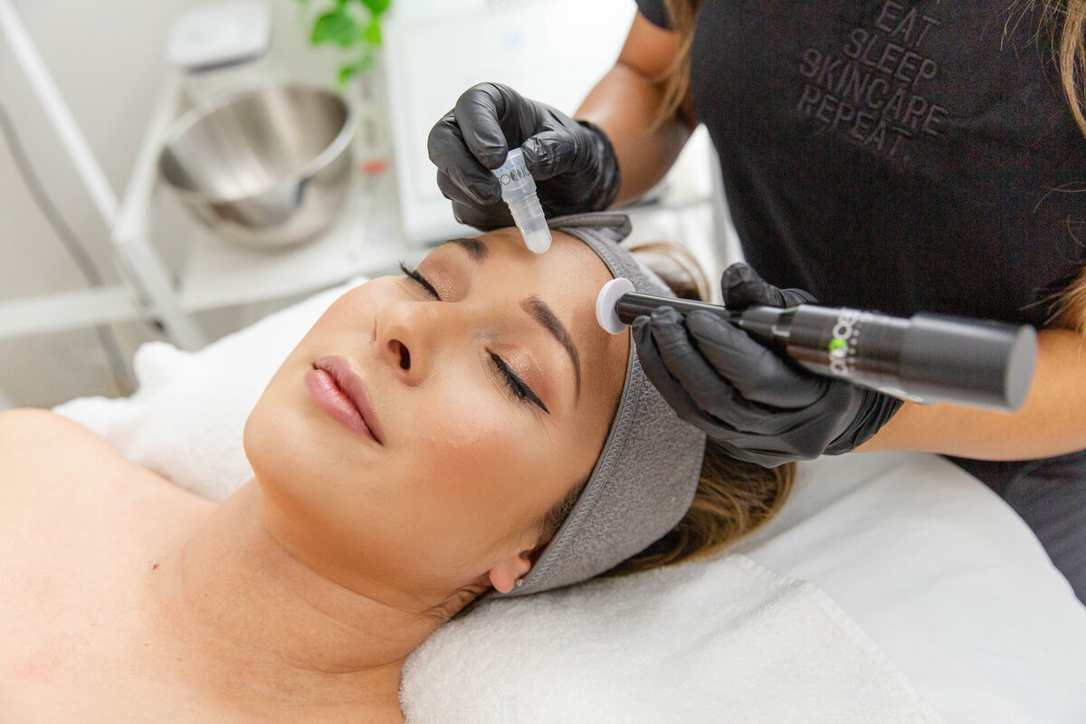 Esthetician performing a Microchanneling procedure in San Diego during a facial