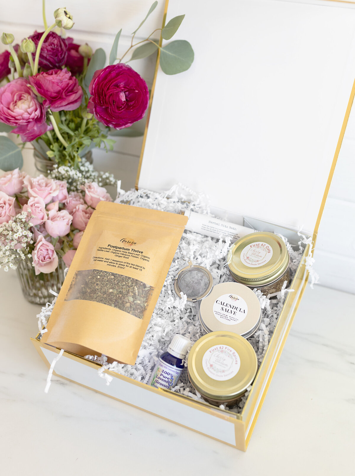 Dried postpartum tea in a bag with glass jars in a gift box