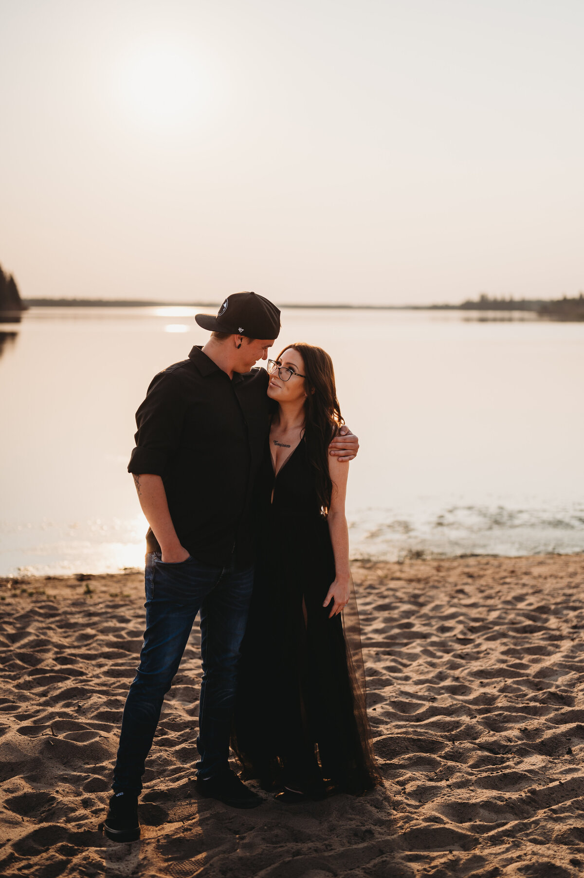 engaged couple on the beach in Elk Island Park