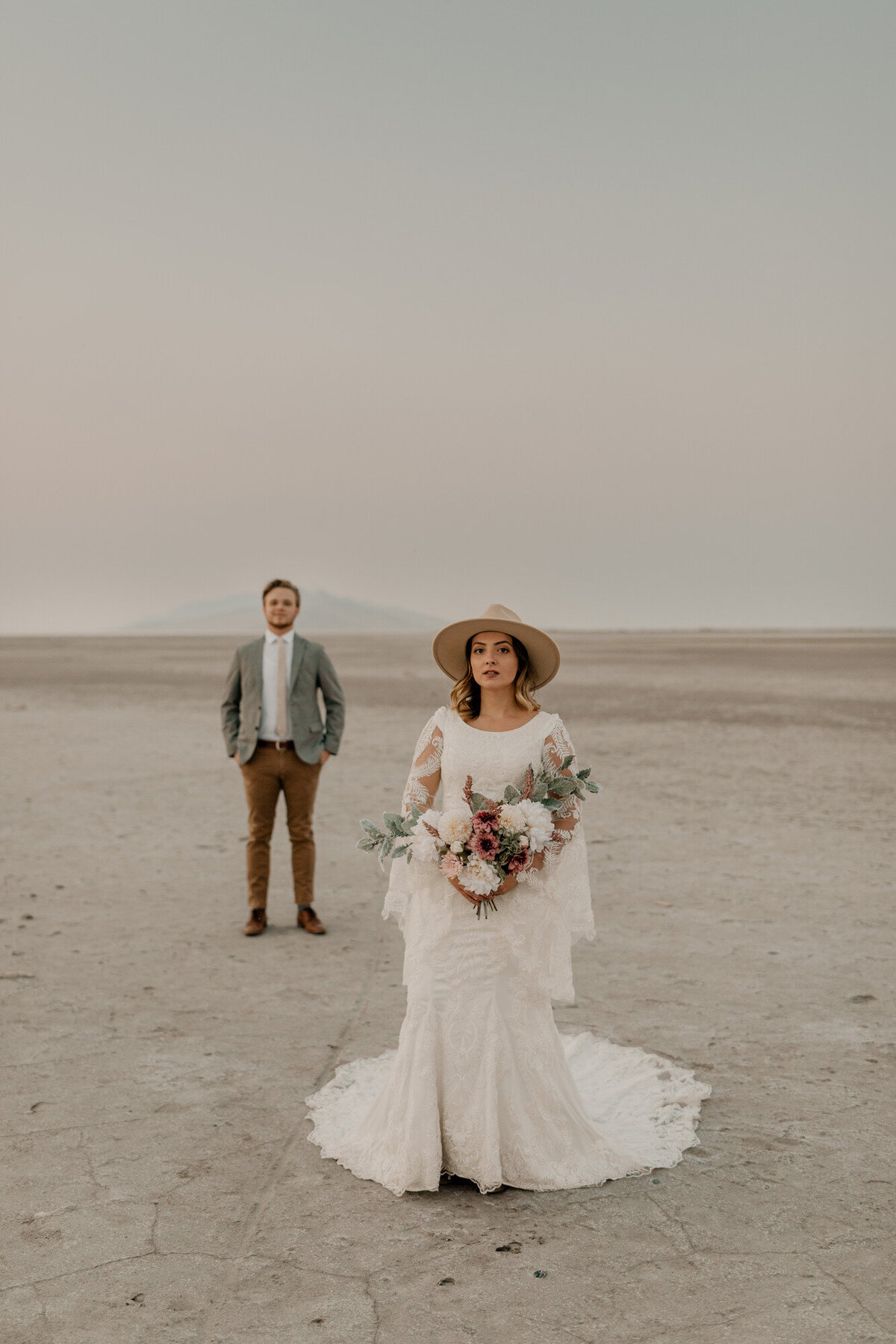 bride and groom standing in salt flats