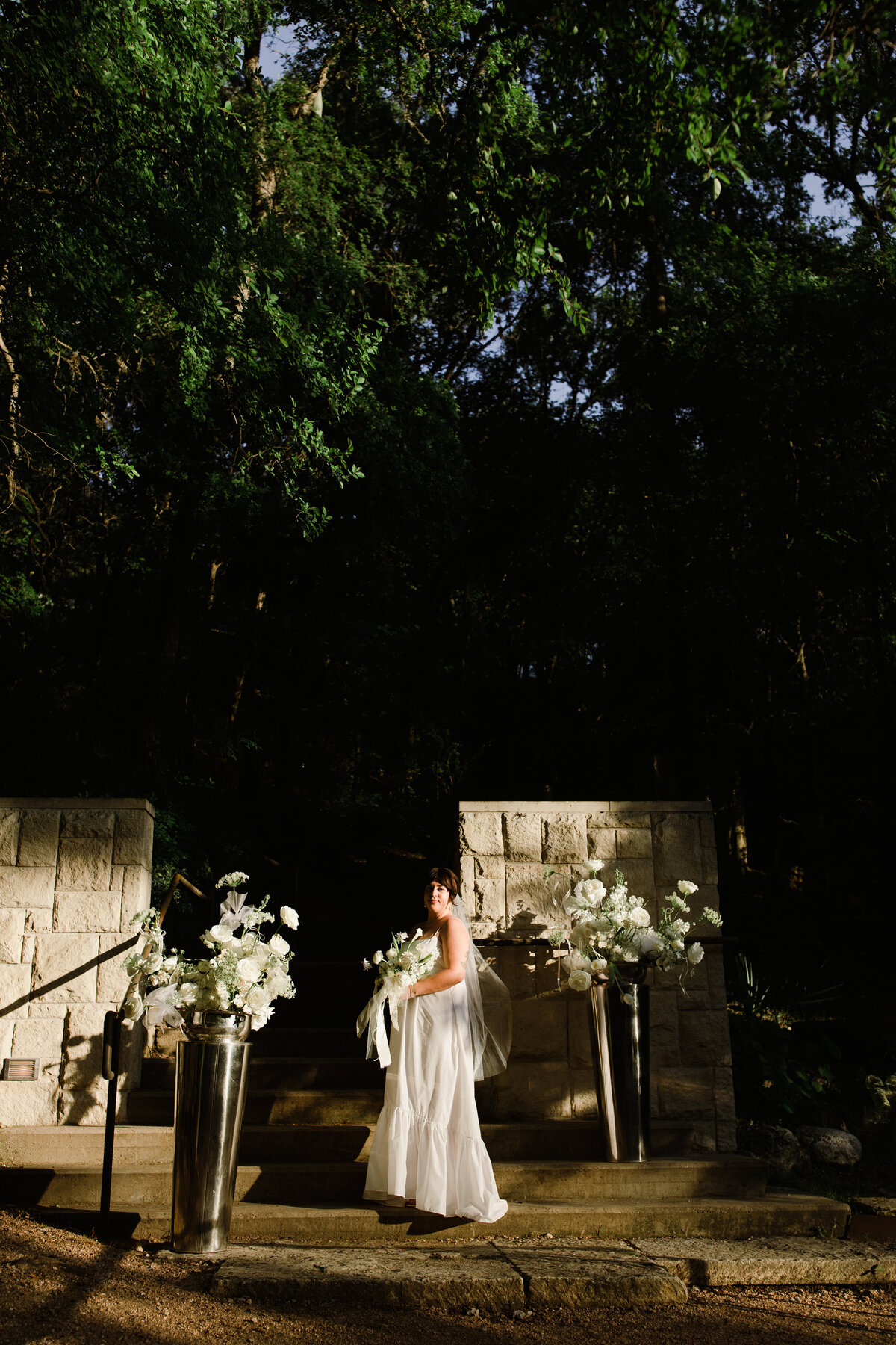 Bride at ceremony site at Couple portraits in the grounds of Umlauf Sculpture Garden, Austin