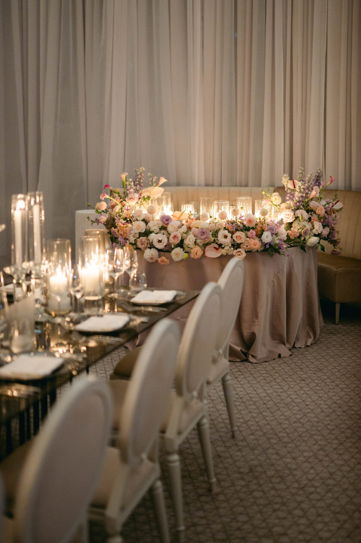 An intimate corner table adorned with pastel flowers at a Four Seasons wedding reception.