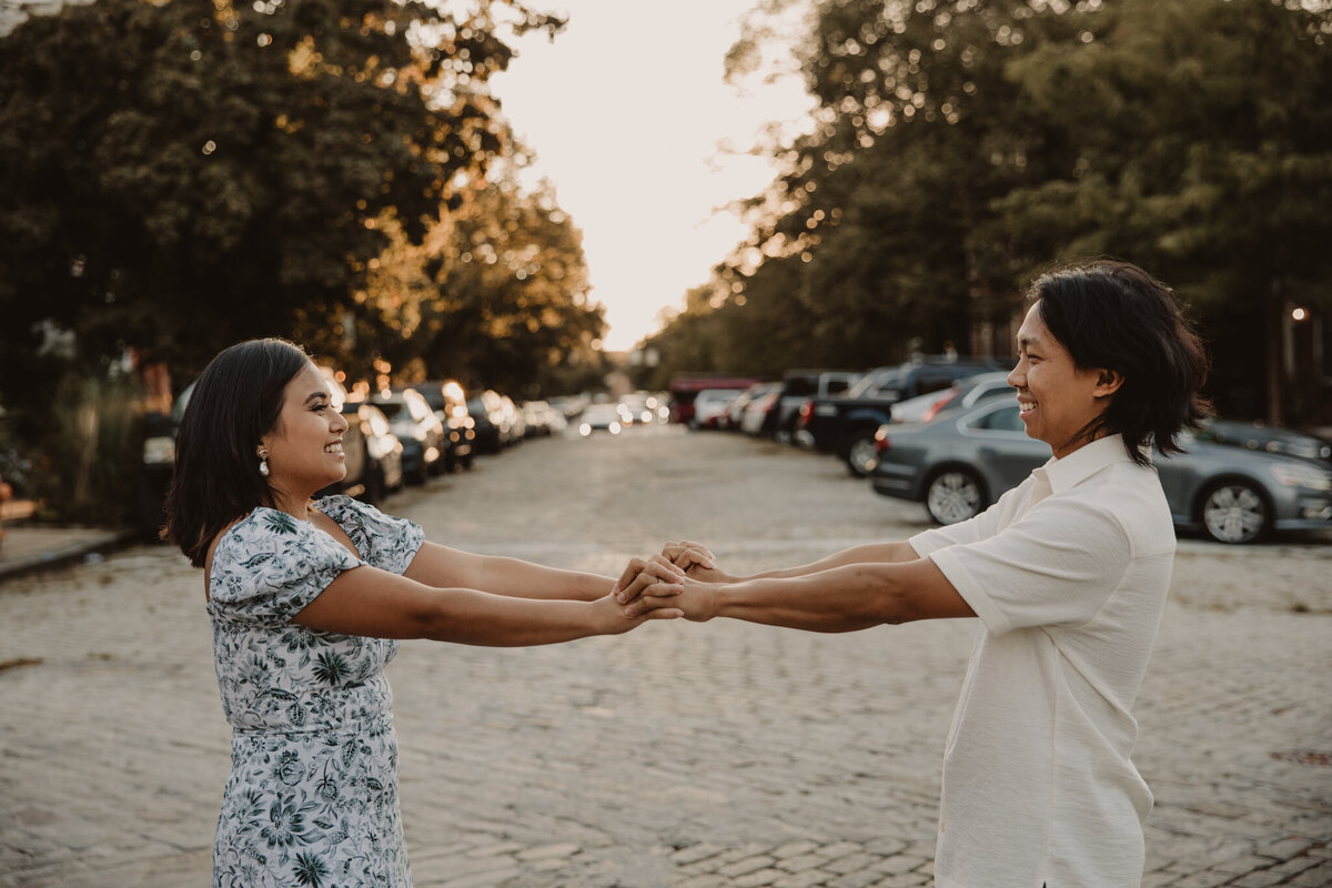 A couple dancing together in the street 