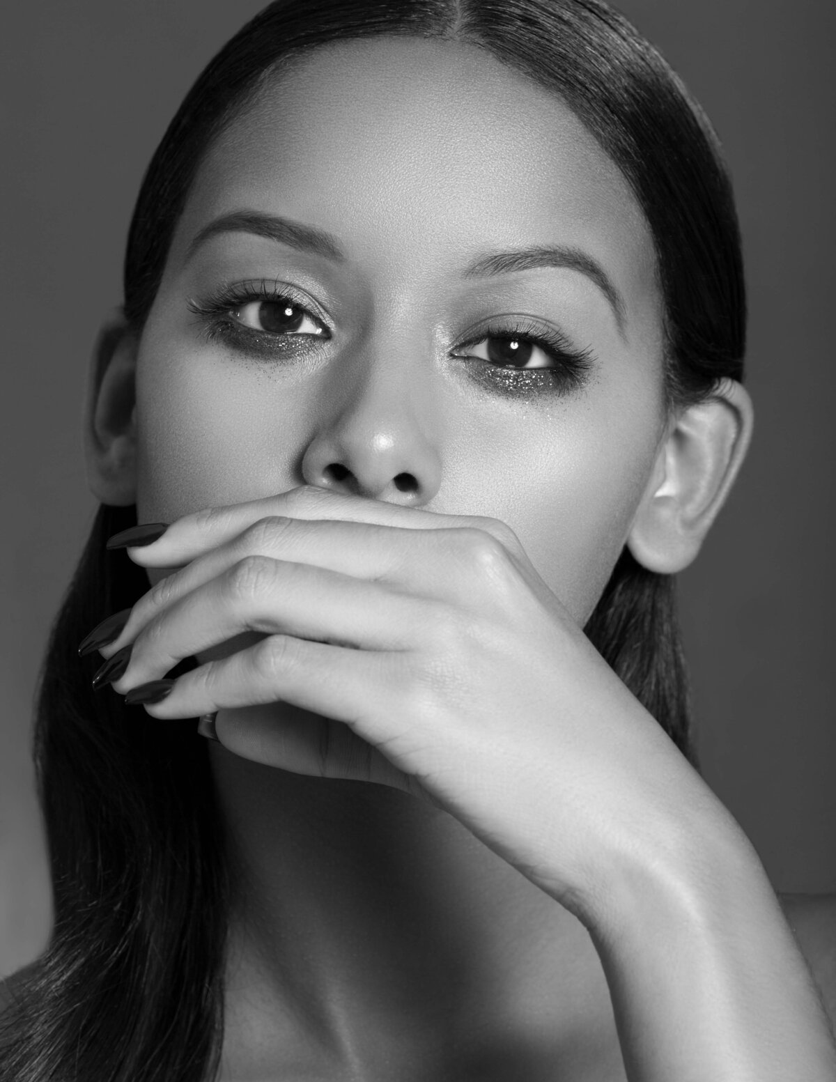 Beauty portrait of this stunning woman covering her mouth