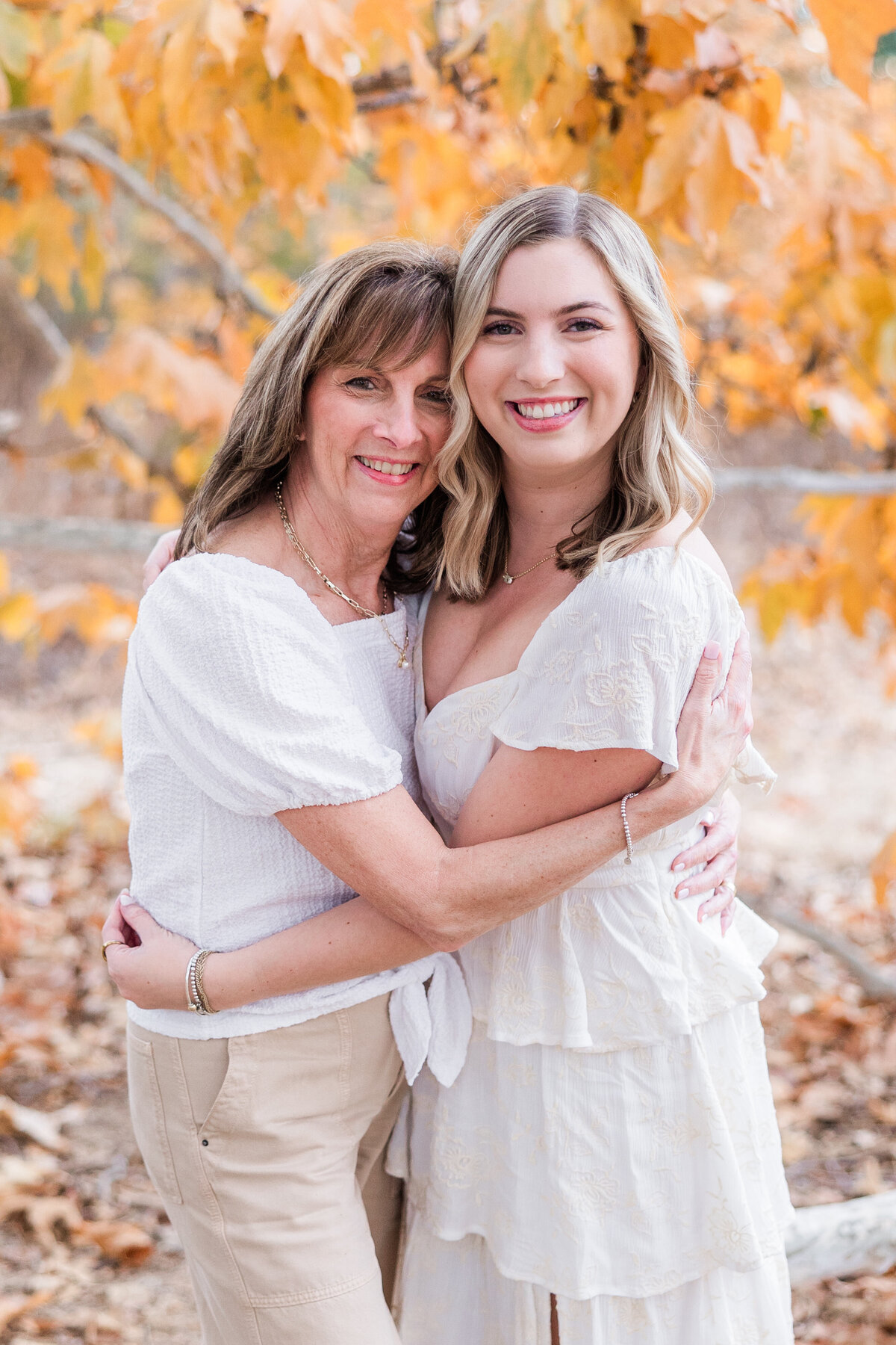 mother and daughter hugging by fall leaves san diego
