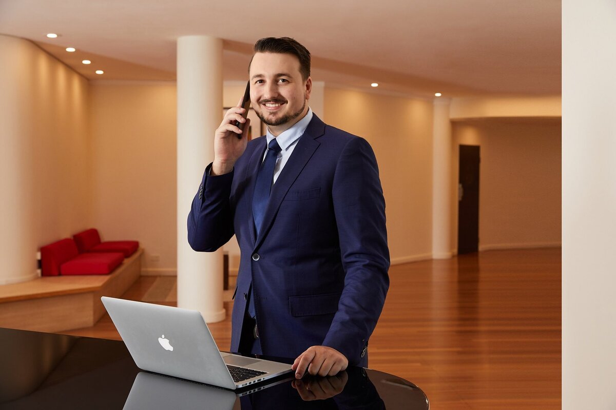 Lawyer using phone with laptop at Shangri la cairns