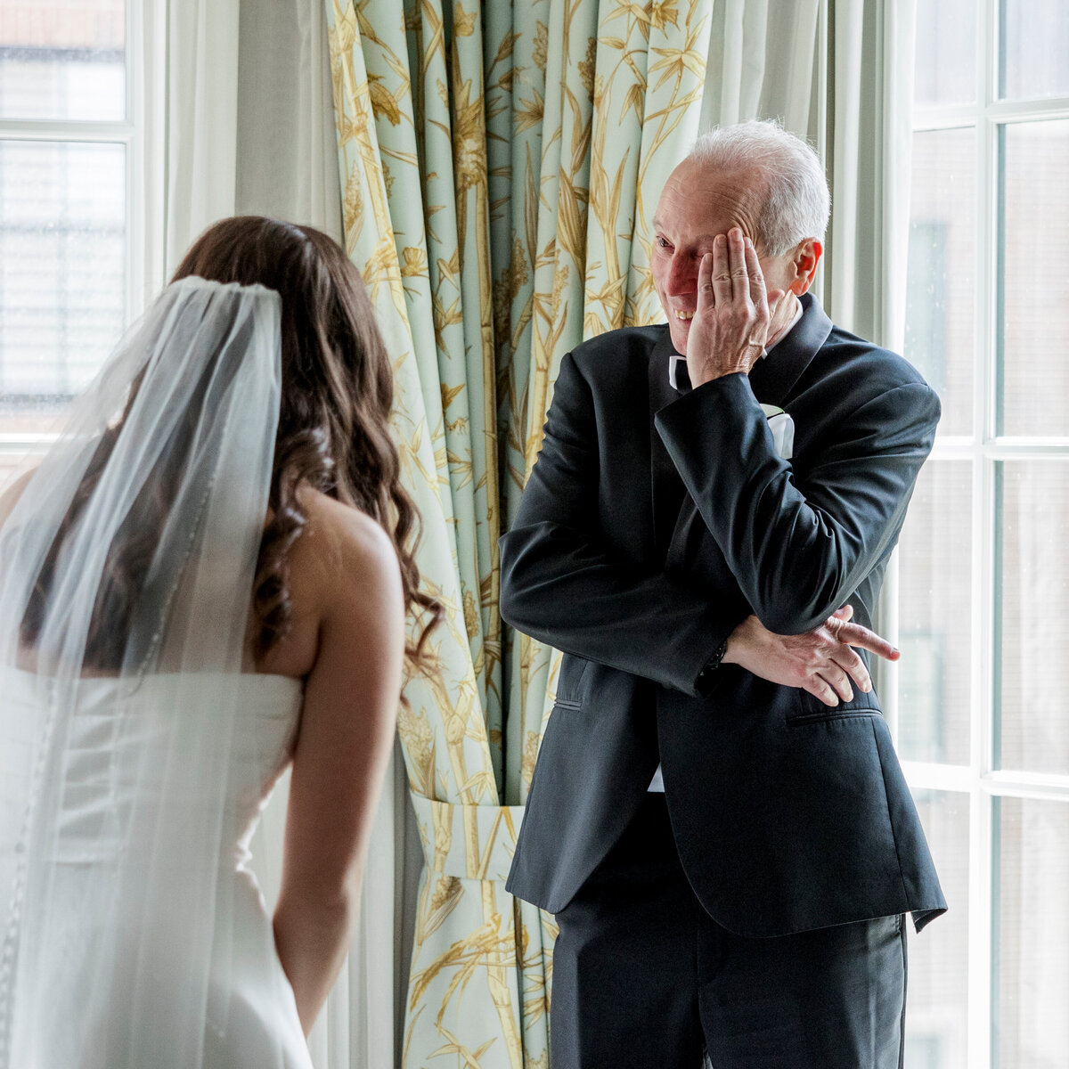 A brides emotional moment with her father during their first look at the Royal Park hotel in Rochester Michigan.