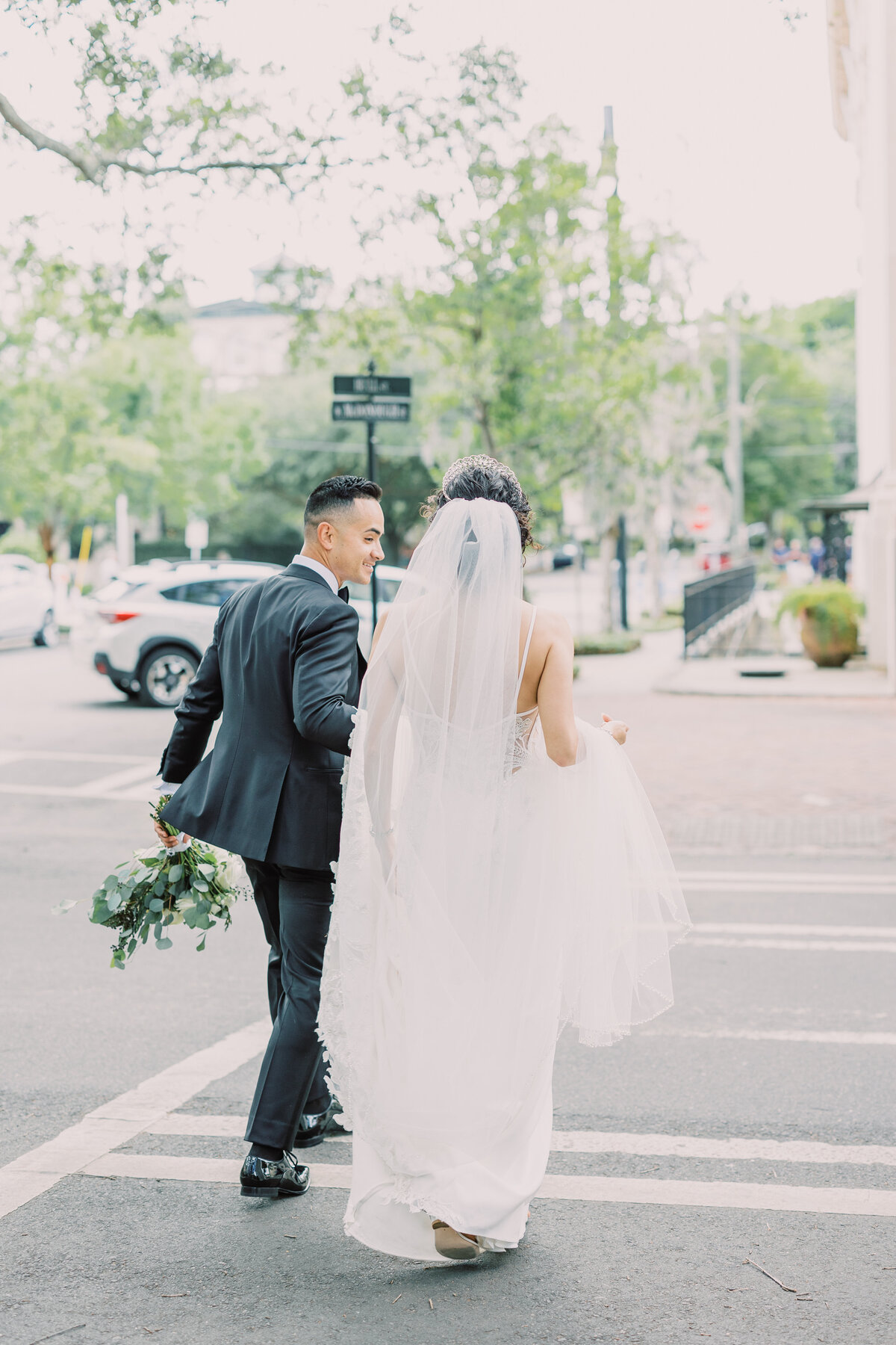 bride and groom crossing a street