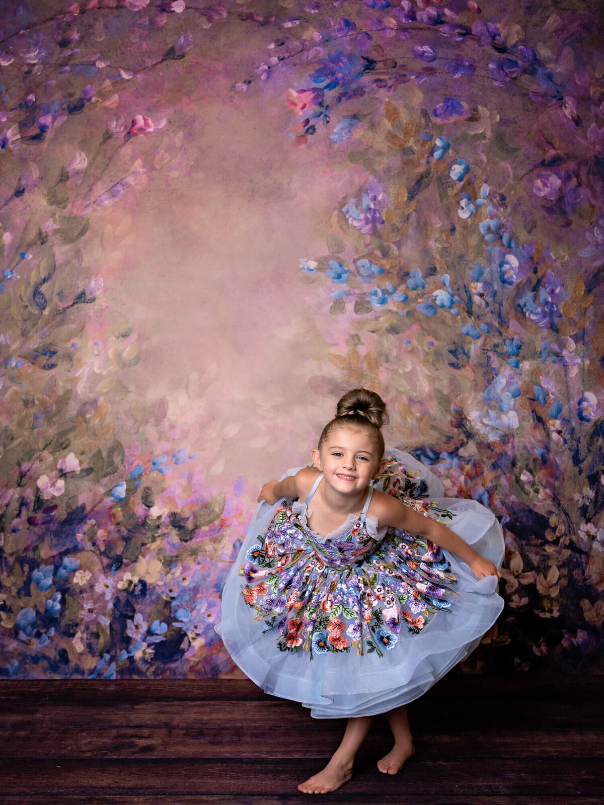 Young girl shows her princess curtsy in dream dress during Prescott kids photography session with Melissa Byrne