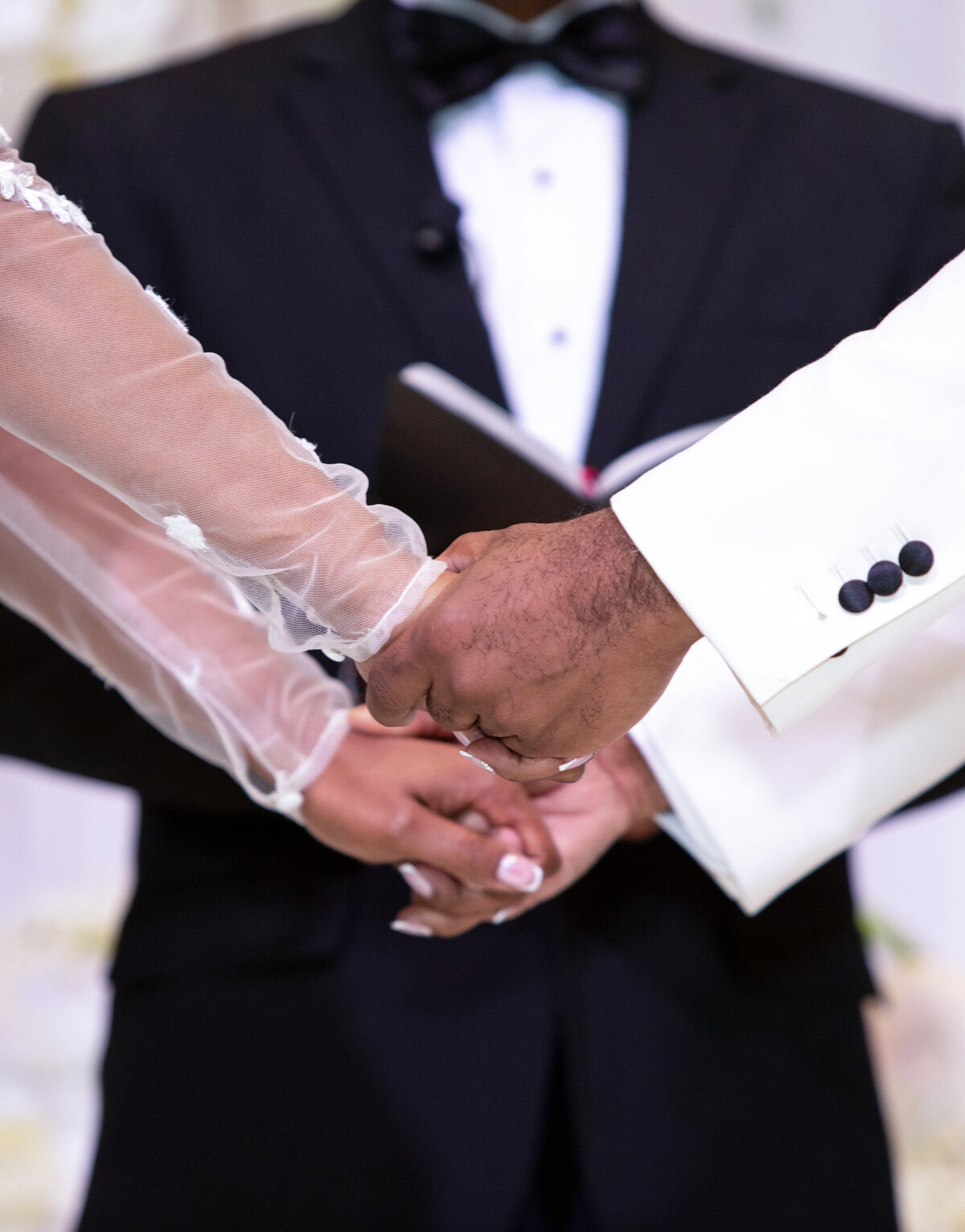 southern-exchange-ballroom-atlanta-wedding-ceremony-holding-hands-closeup