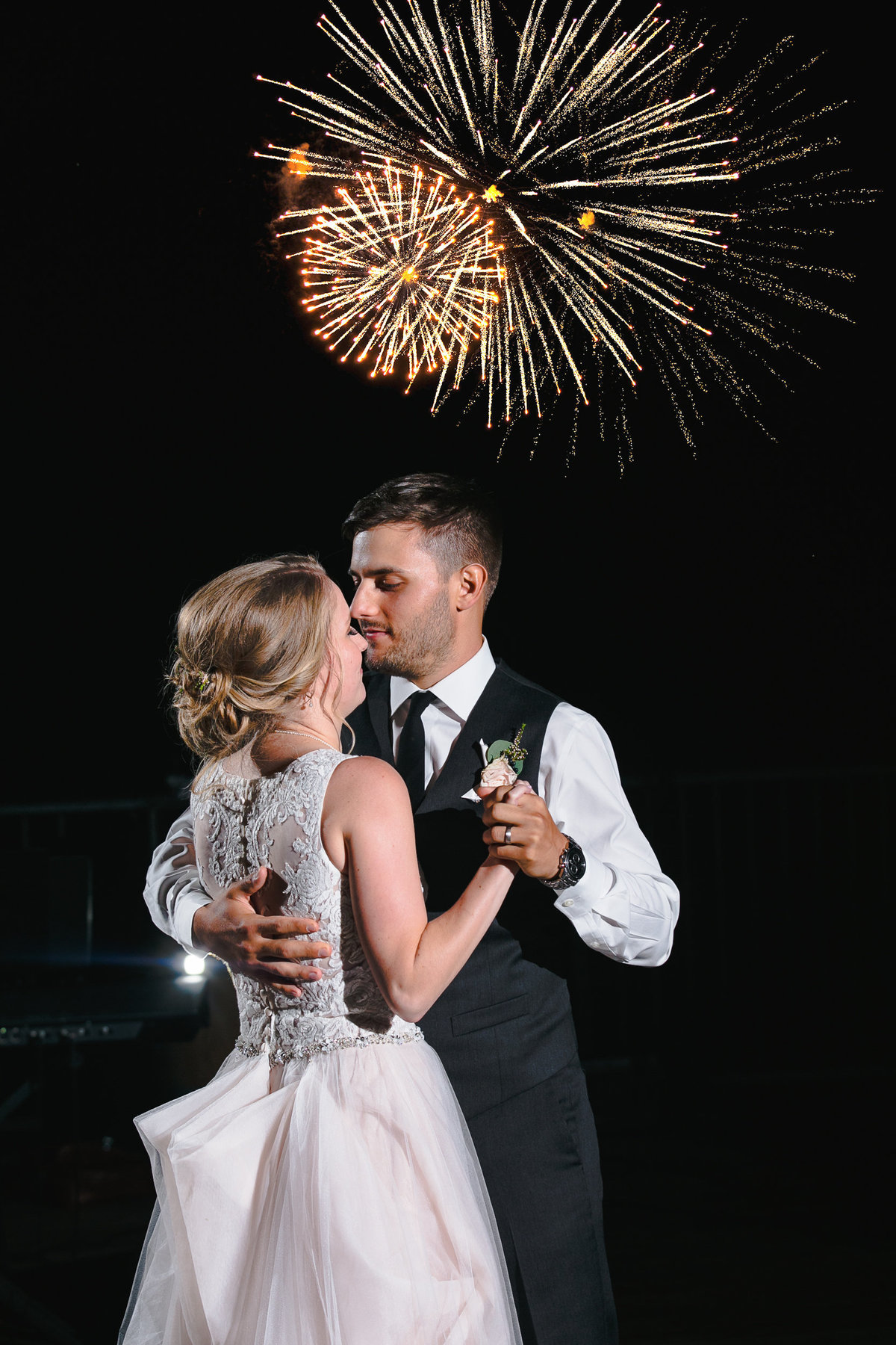 Bride and Groom share their first dance under a night sky filled with fireworks.