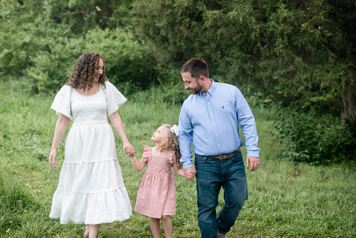 Photography in Bowling Green, KY: Picture of a mother, father, and daughter holding hands and walking.