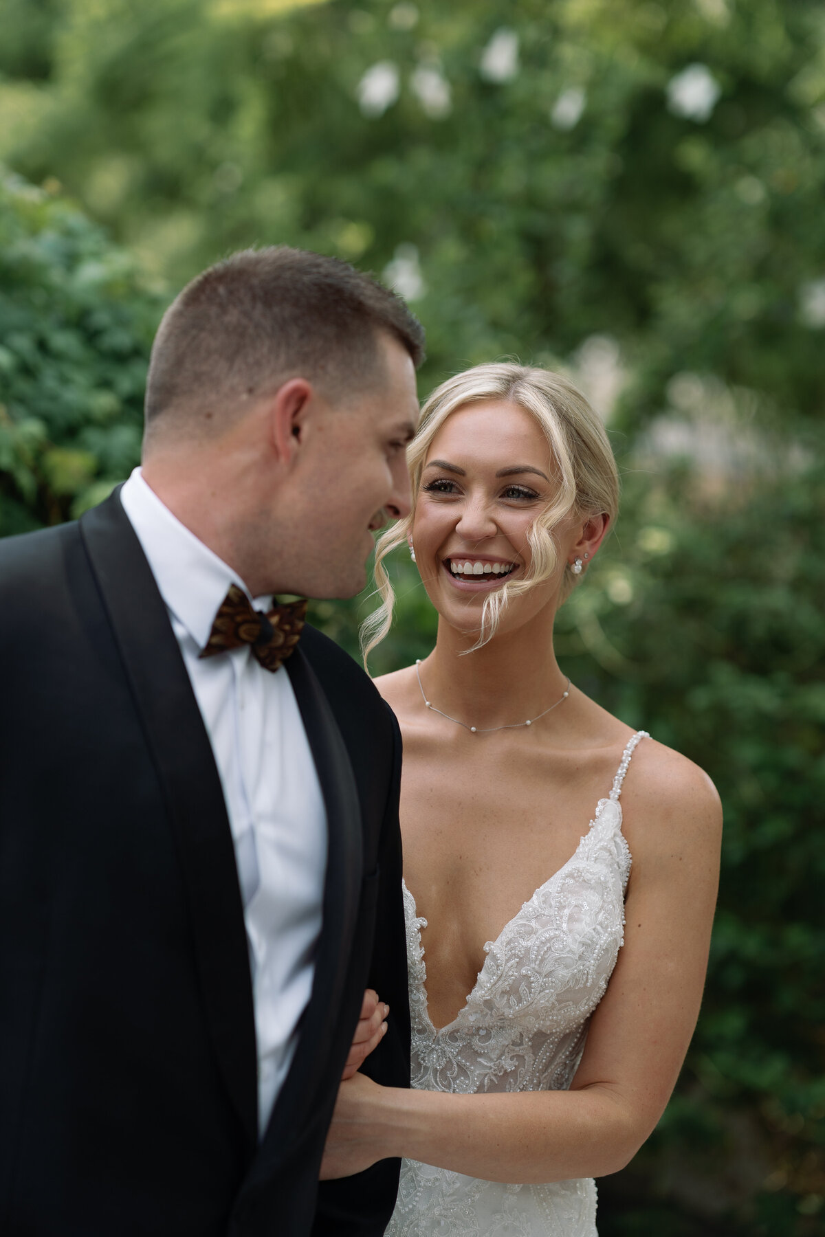 Bride smiling and laughing at groom with film style wedding photography