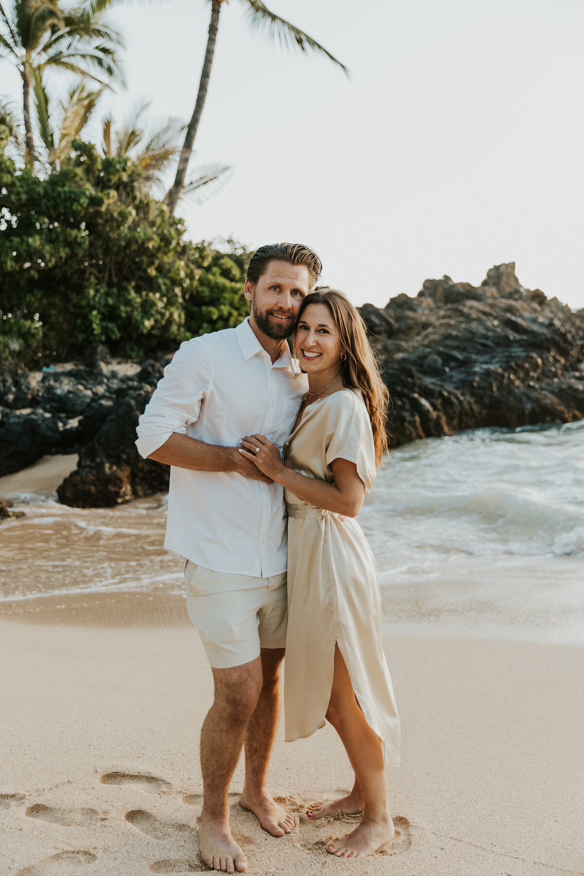 Hawaii Engagement Photographer captures man and woman hugging during beach engagement photos