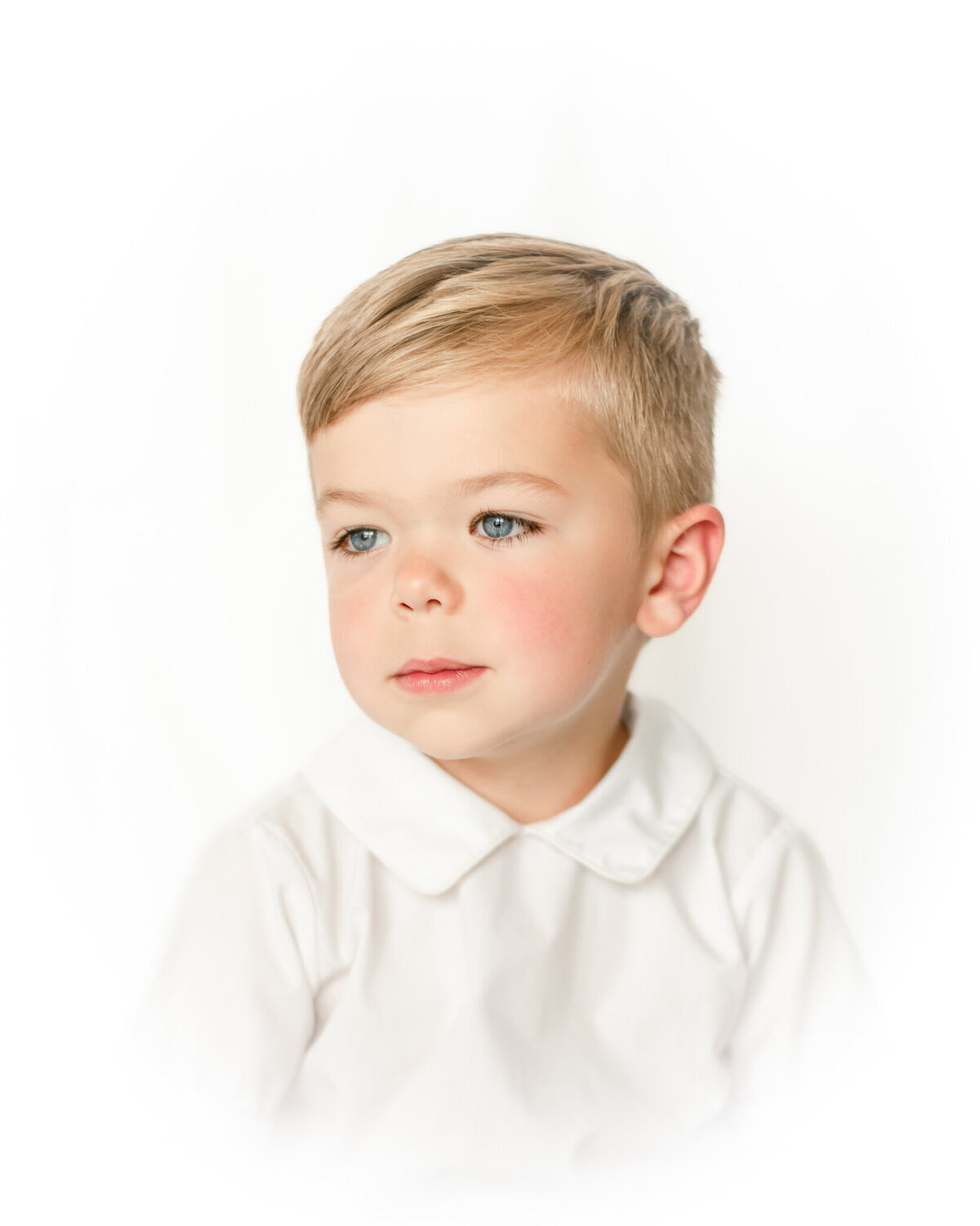 Vignette portrait of a little boy smiling to the side