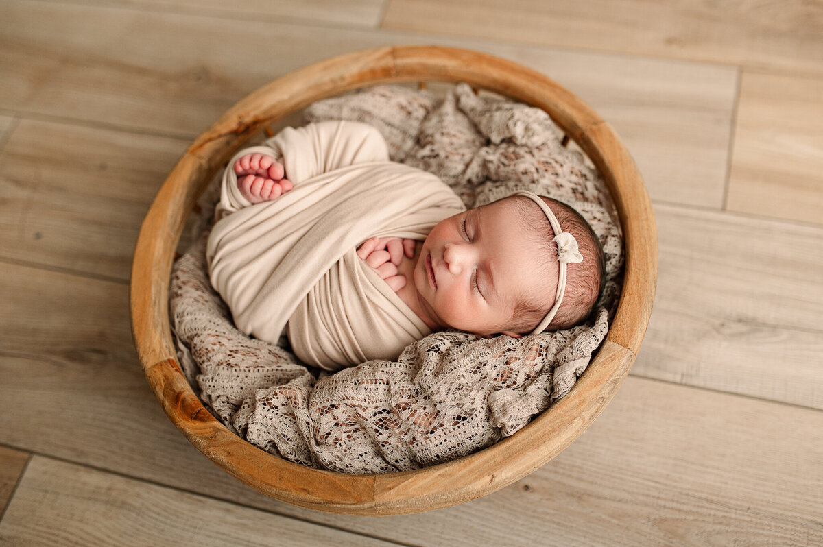Natural light swaddled newborn tan