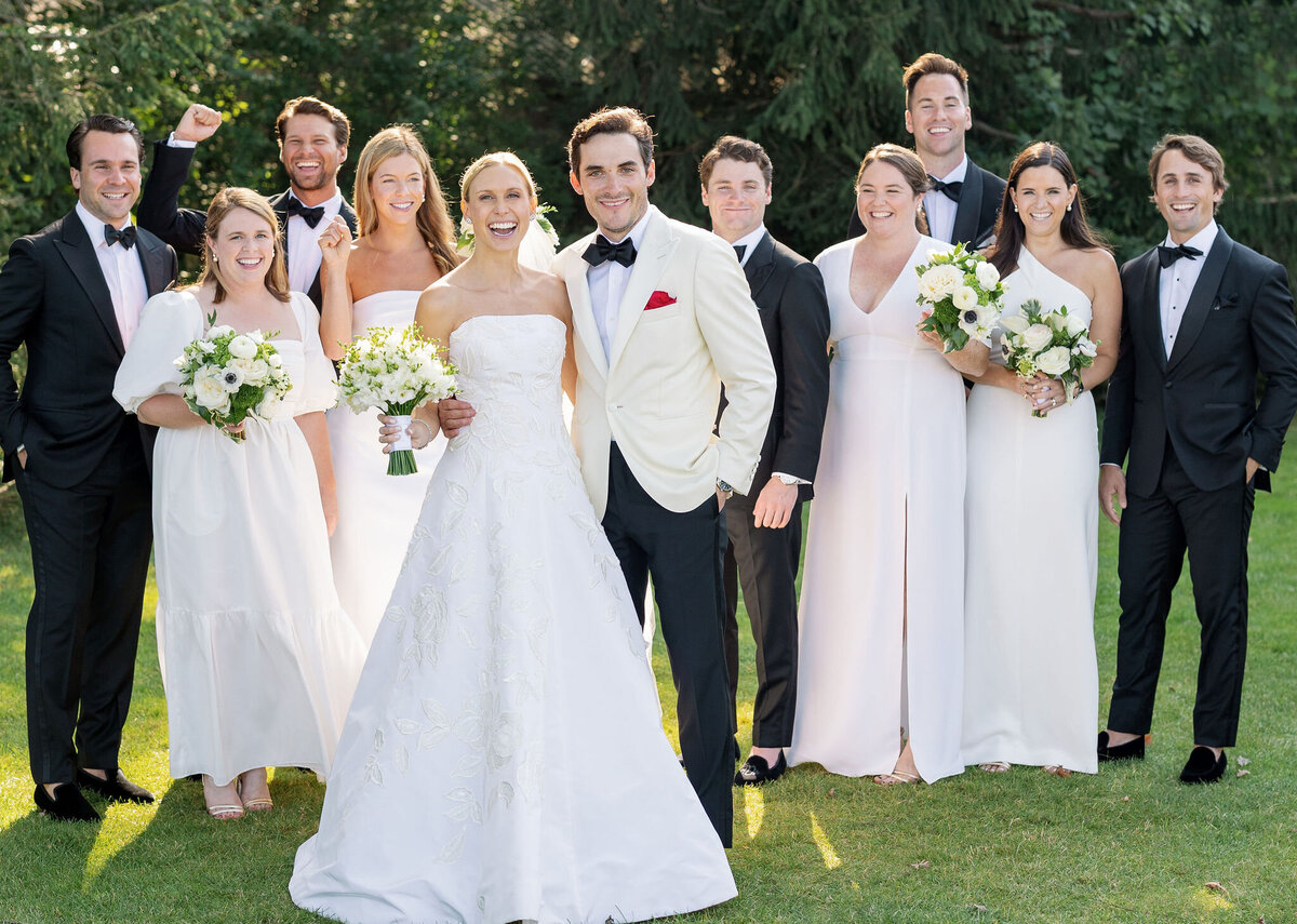 A photo of the bridal party outside on a sunny day. 