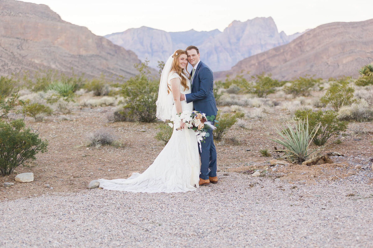 joyful bride and groom in front of stunning Red Rock Canyon in the Las Vegas Desert