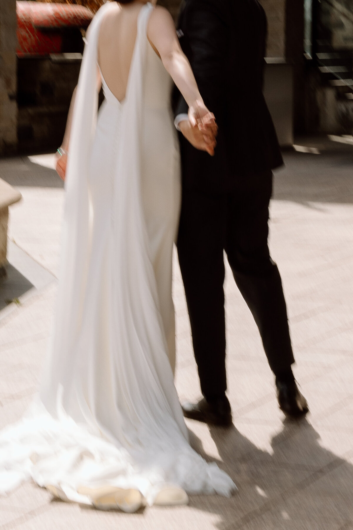A blurry photo showing movement between a bride and groom on their wedding day