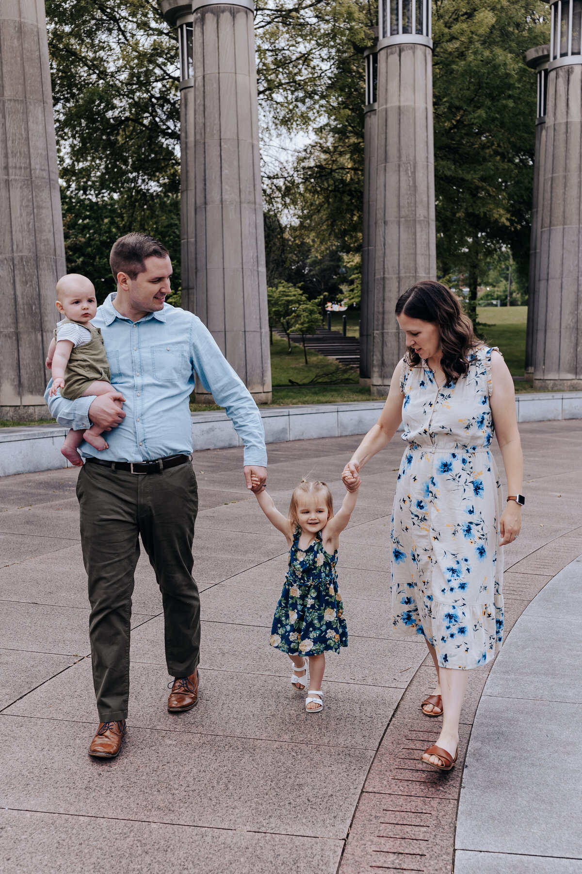 Nashville family photographers capture parents holding hands with daughter