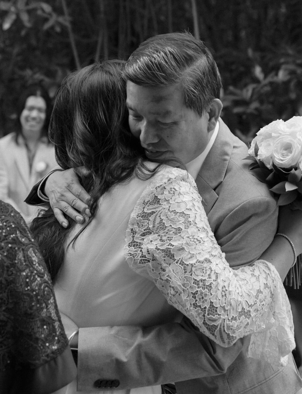 bride hugs father at wedding ceremony, chic pantsuit, Mexico destination wedding