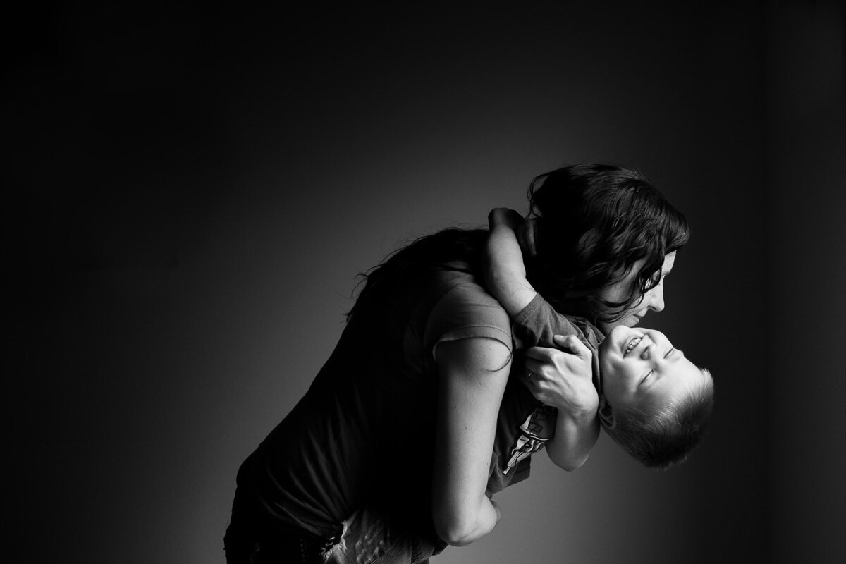 mom and little boy hugging in black and white photo