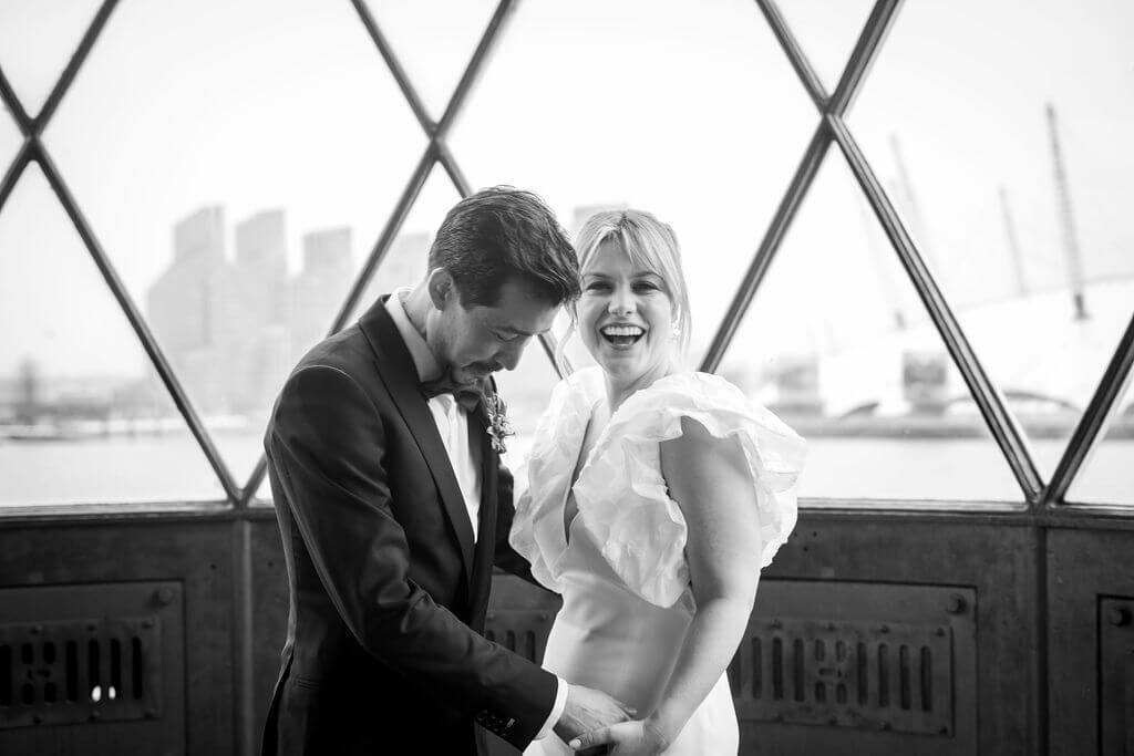 Bride and groom portrait in Trinity Buoy Wharf light house.  Bride laughing