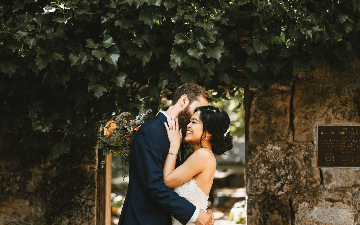 Bride and groom share an intimate embrace outdoors, captured in our documentary style — the same approach we bring to Asheville and Blue Ridge weddings.