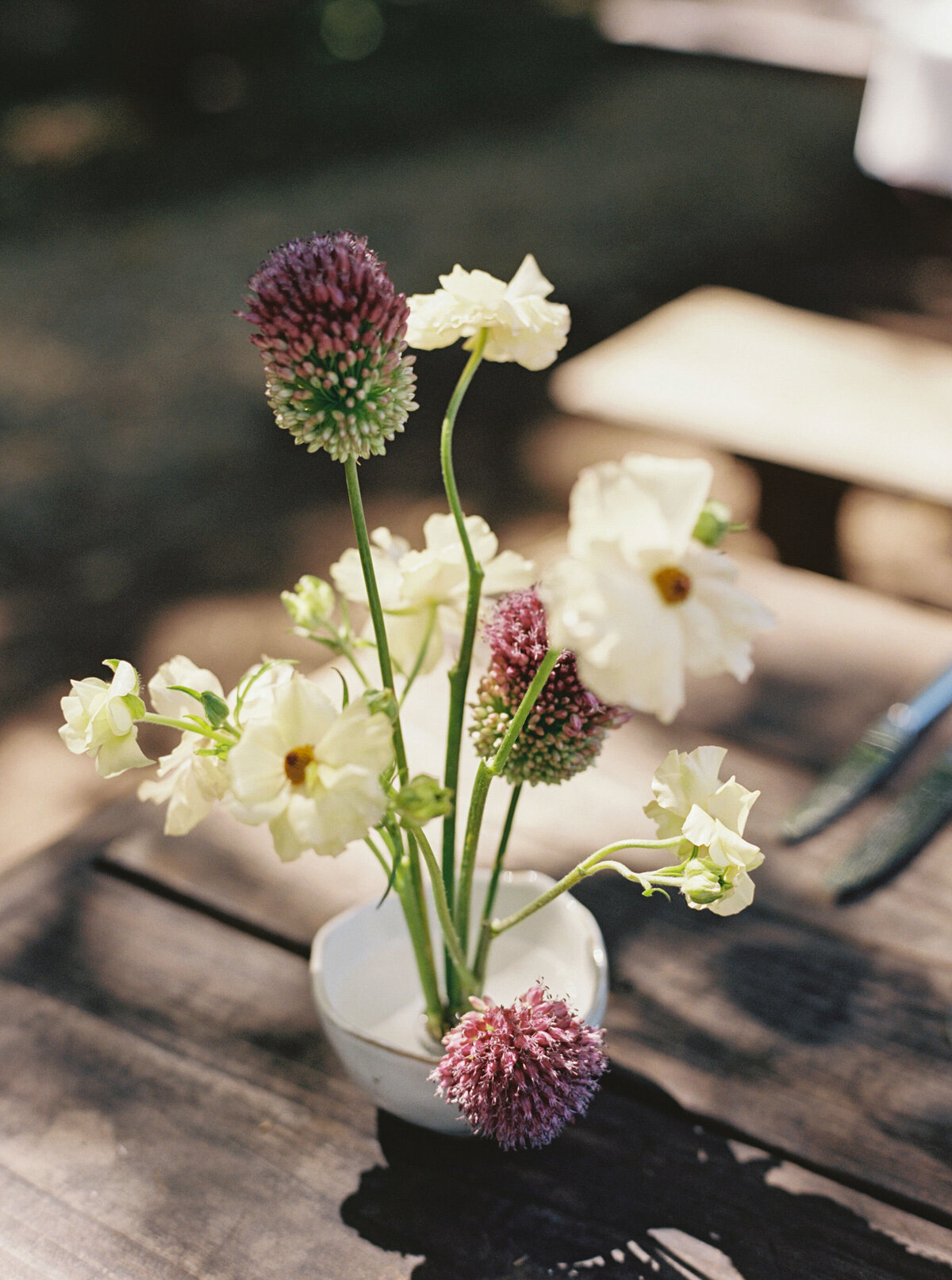 Fall wedding at Blackberry Farm. Welcome party for wedding guests at Yallerhammer Pavilion on property at Blackberry Farm. Growing floral installation with whimsical florals for entrance to reception. Rustic and earthy floral design with elegant notes of blush and cream. Wildflower design in ikebana style with glowing candlelight reception tables. Destination wedding at Blackberry Farm. Design by Rosemary & Finch Floral Design in Nashville, TN.
