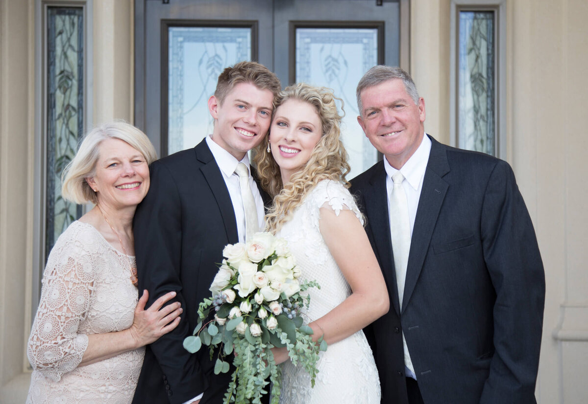 a wedding couple and parents at their lds temple wedding