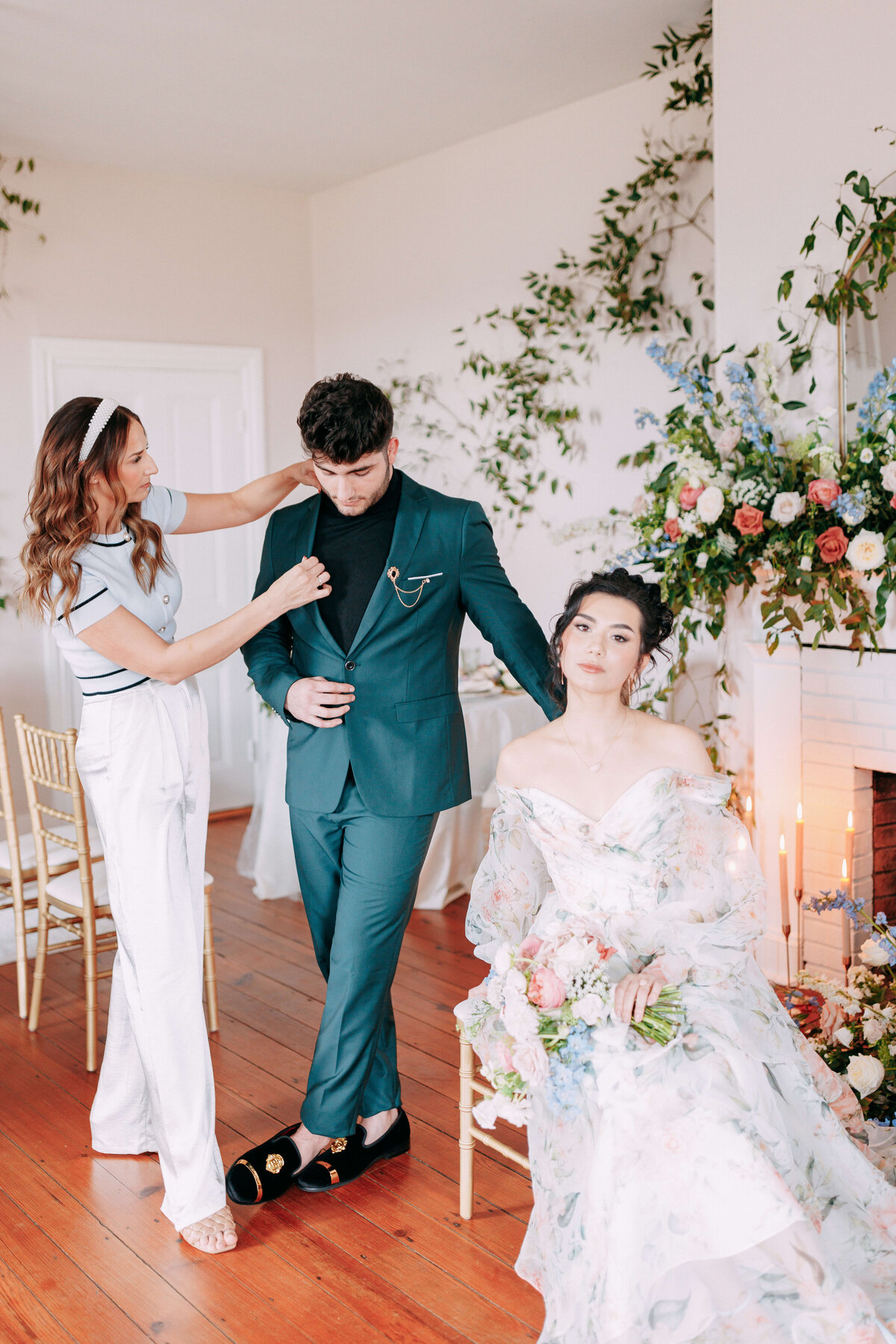 floral designer and planner adjusting grooms suit for bridgerton inspired wedding