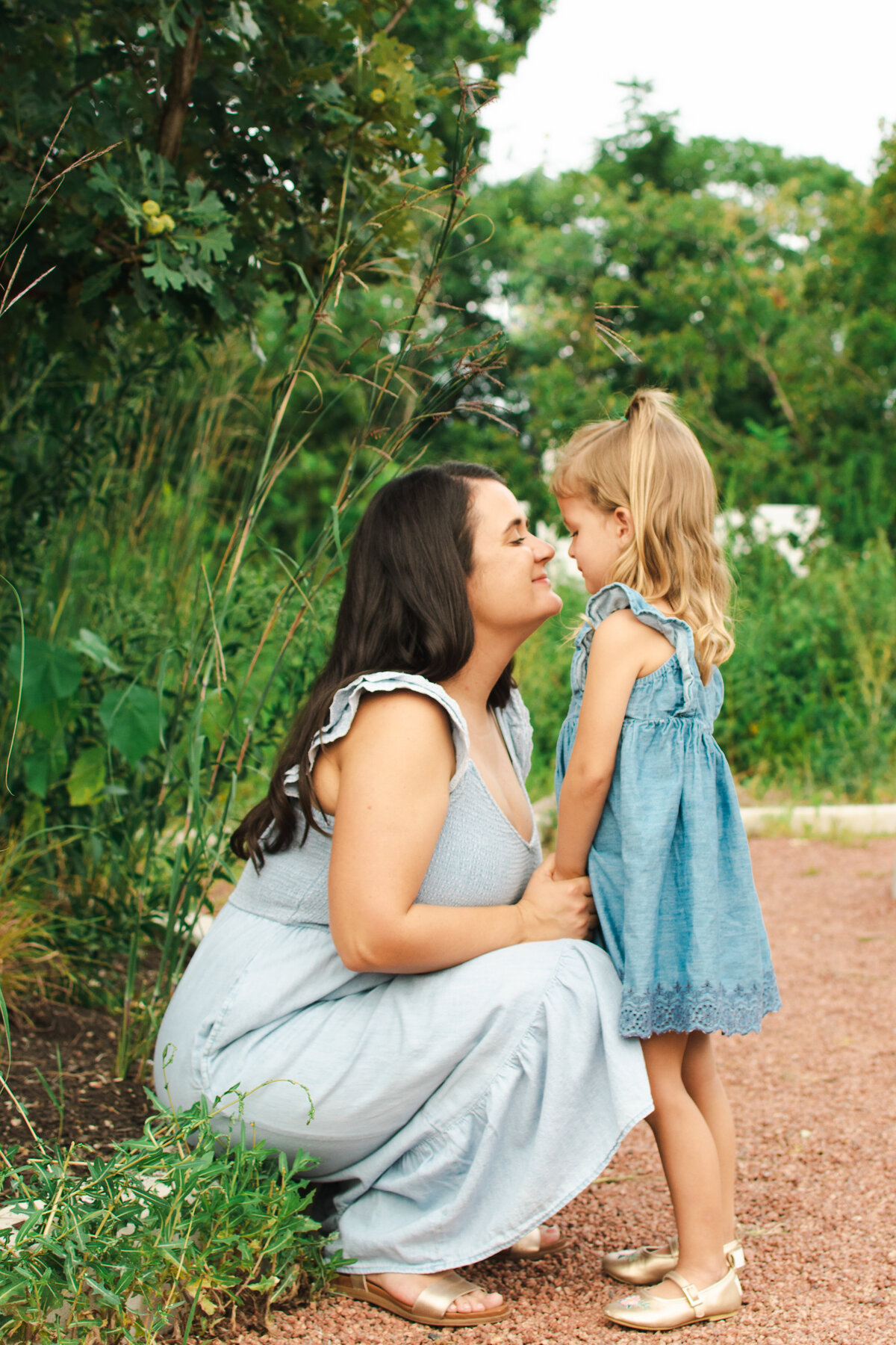 Mom and young daughter having a sweet moment during a family photoshoot in Spring Valley Nature Center, Schaumburg, IL