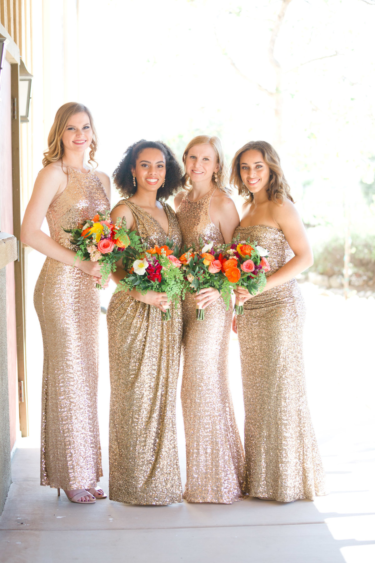 bridal party portrait in rose gold bridesmaids dresses