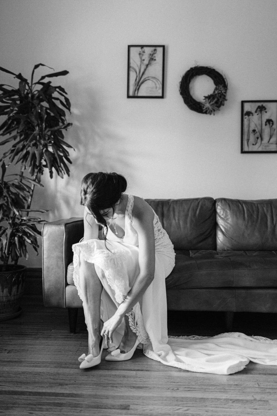 Bride puts on shoes and is captured by the top wedding photographer in Calgary
