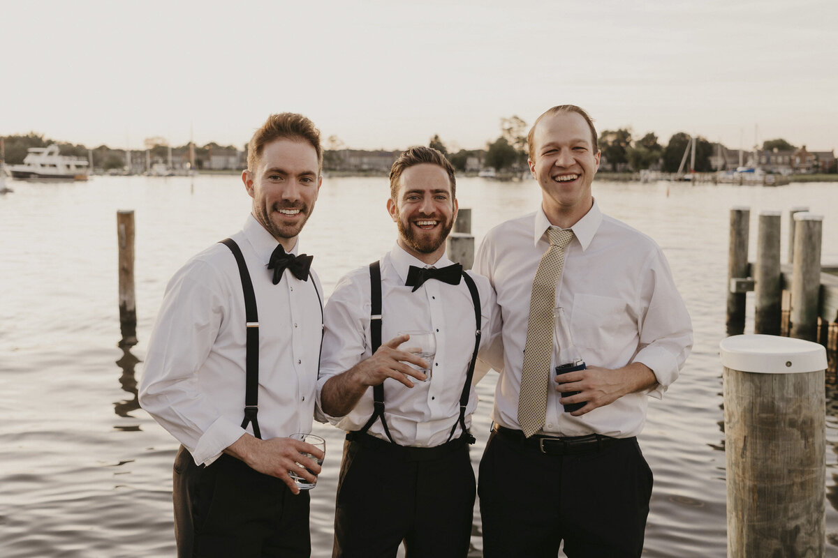Groomsmen celebrating on a dock