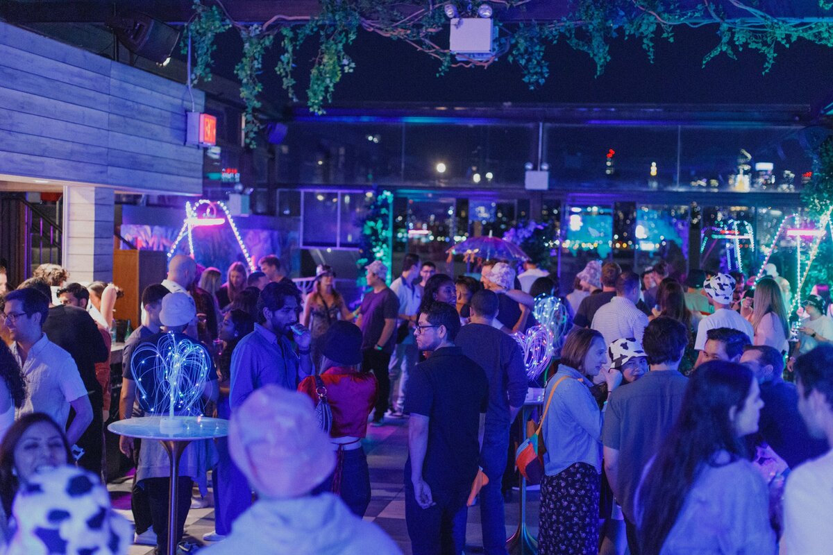 Guests mingling under glowing neon décor.