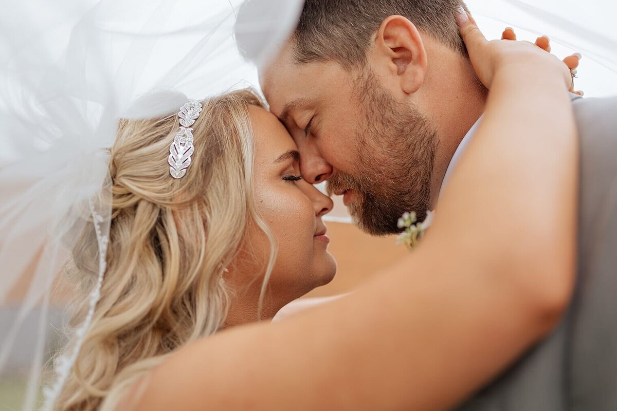 bride and groom having intimate moment. photographed by Michelle Wedding and elopement photographer