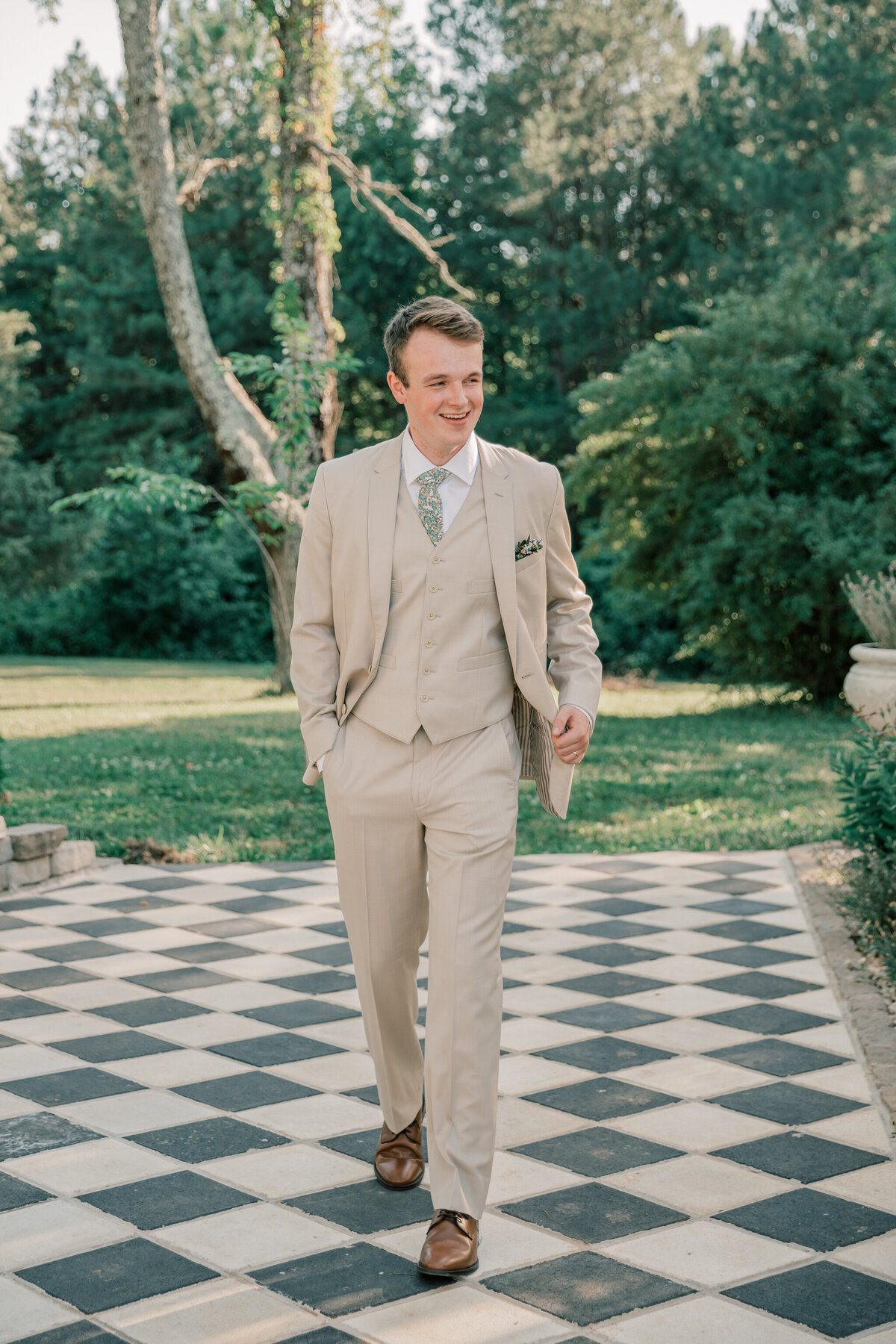 Groom walking outside of the greenhouse at Three Oaks Manor