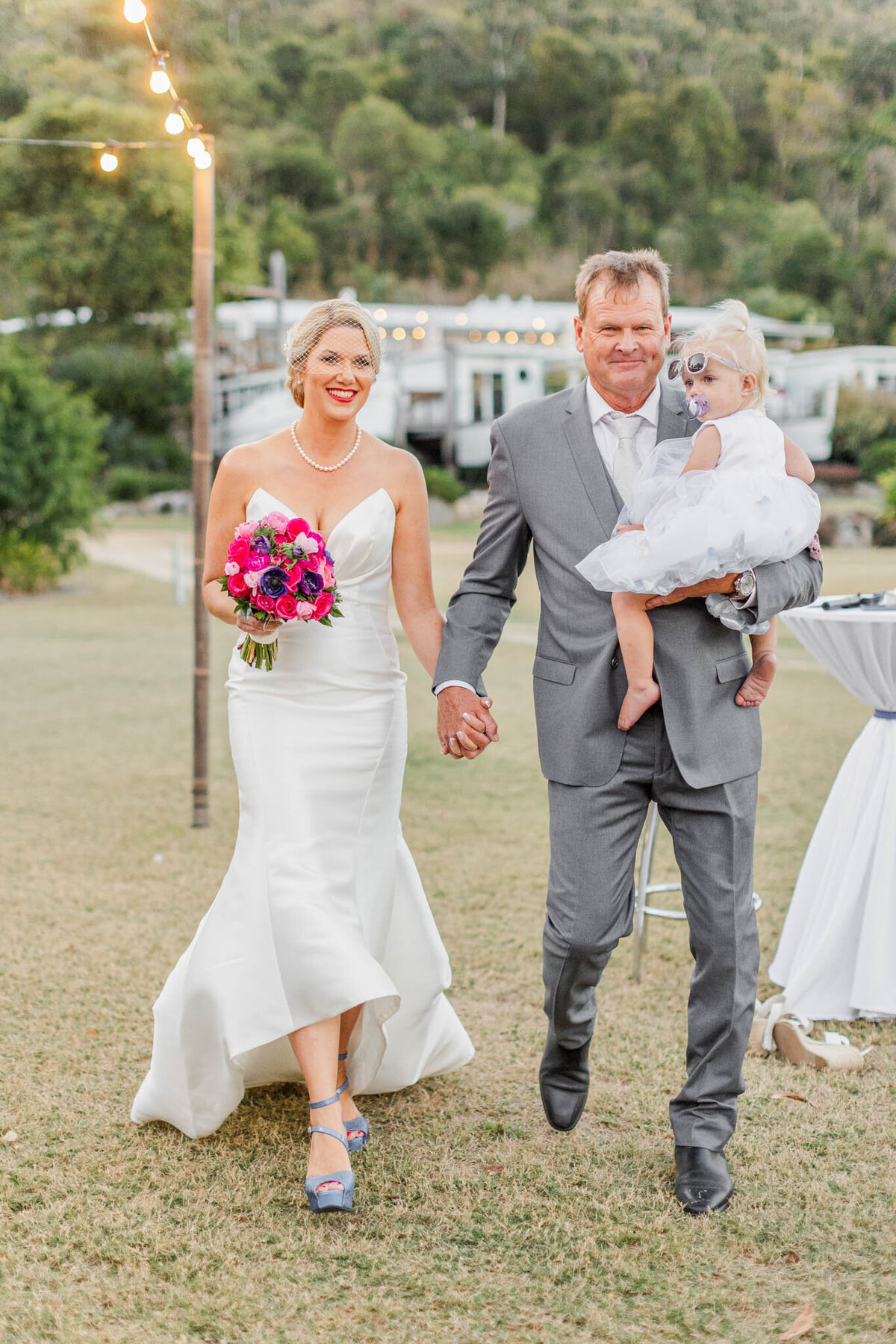 Newlyweds enter their receptions at freedom shores in Airlie beach