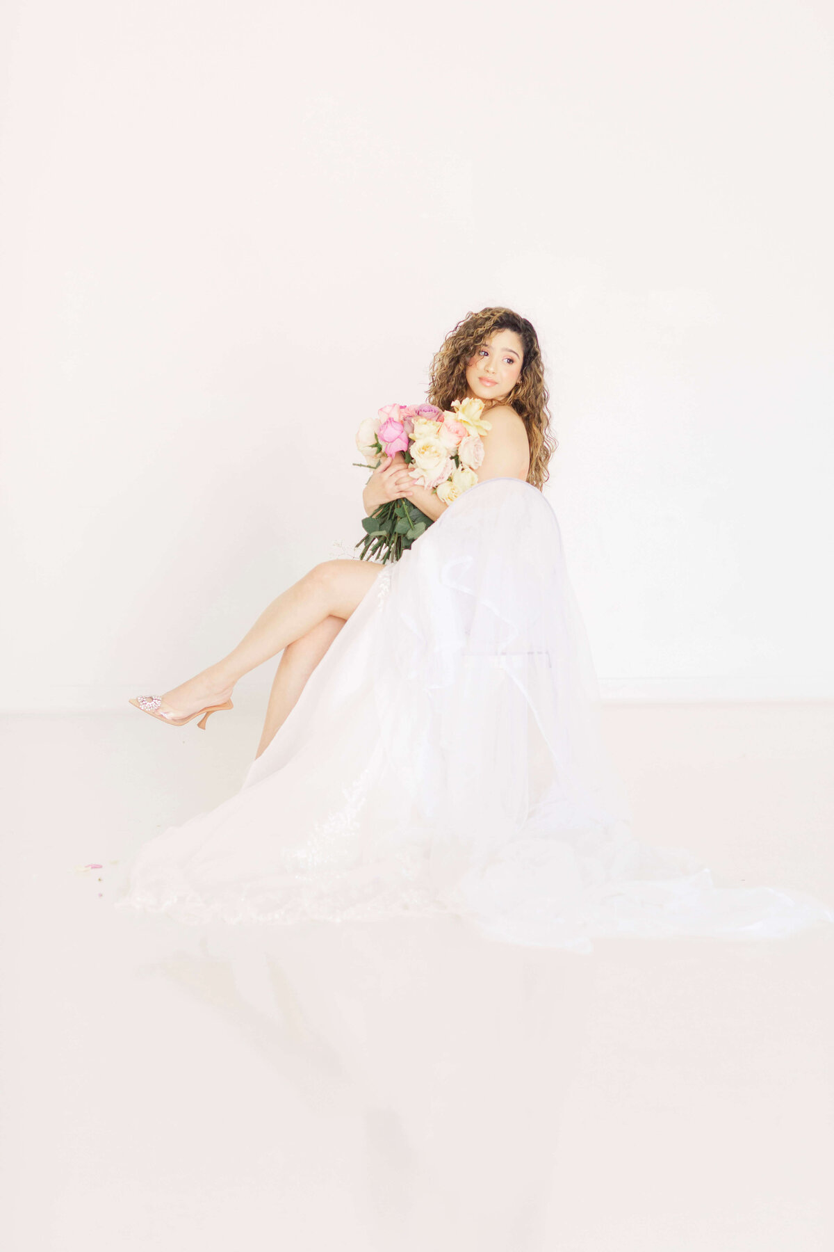 bride holding a bunch of roses