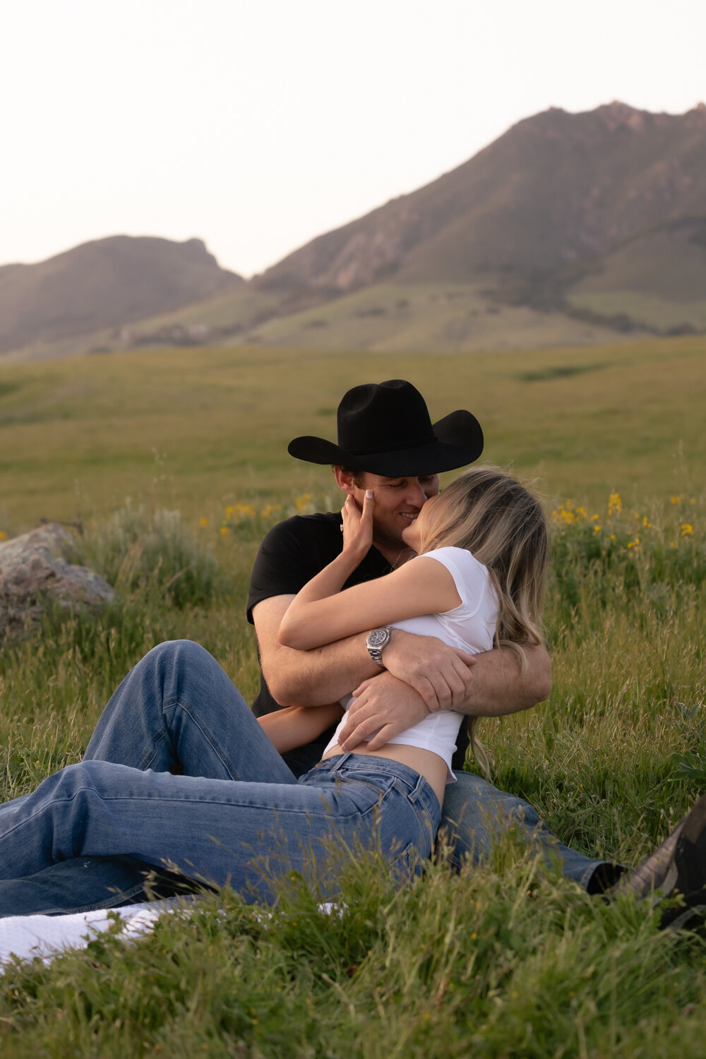 Candid couple sitting laying kissing during engagement photos San Luis Obispo on Central Coast 